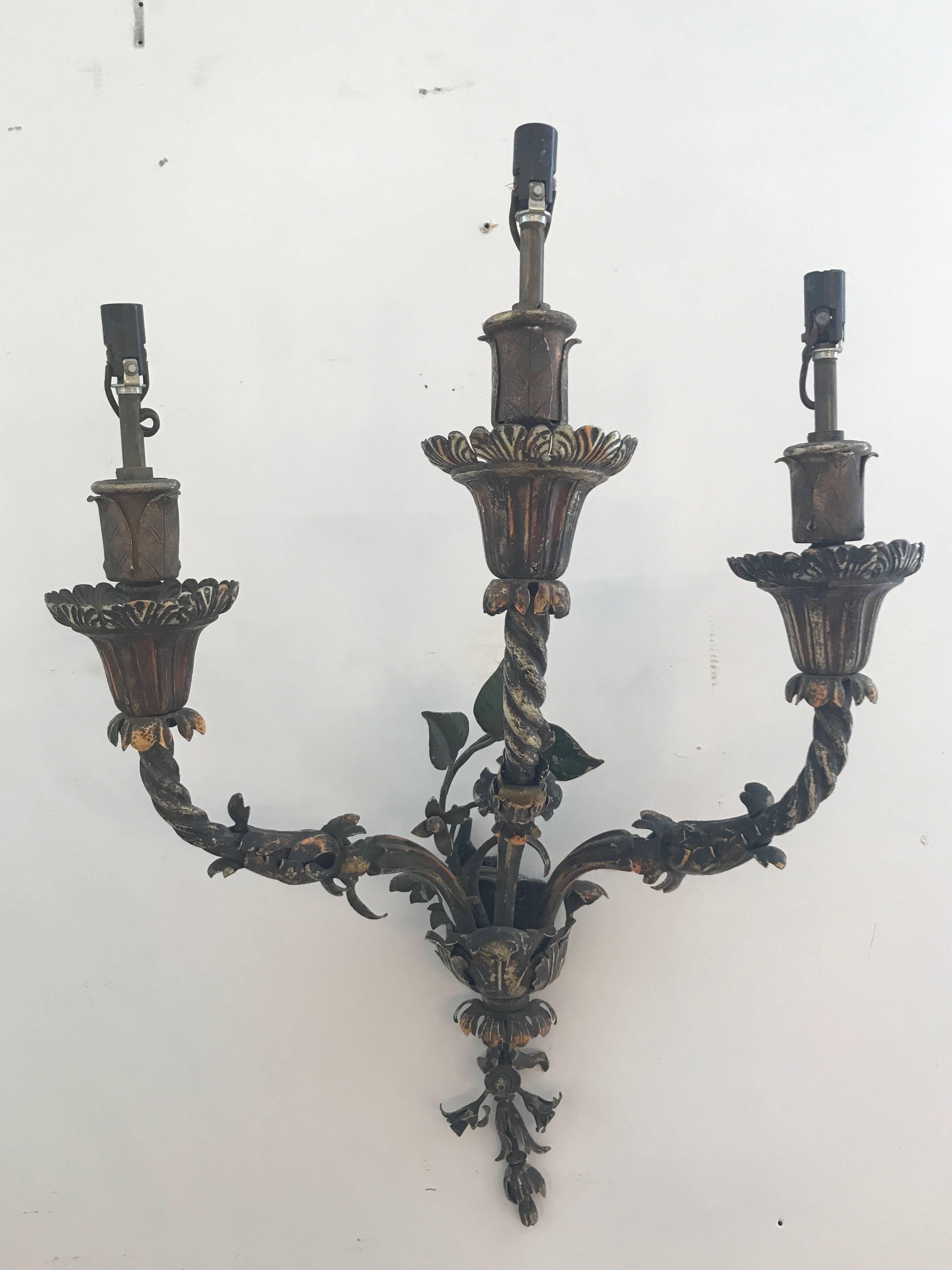 Pair of Early 20th Century painted iron sconces. With worn paint and foliate details.