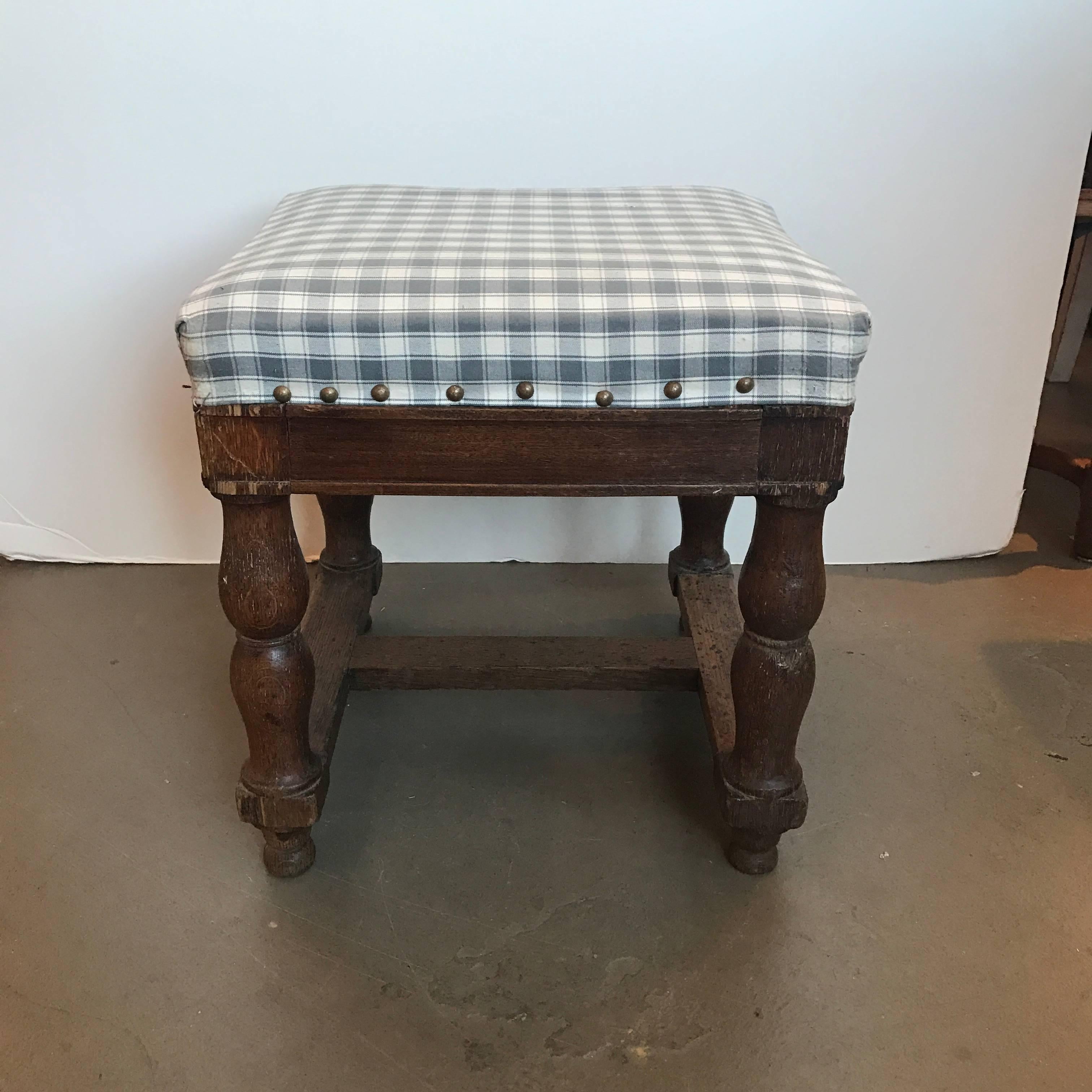 19th century upholstered stool with nailheads.