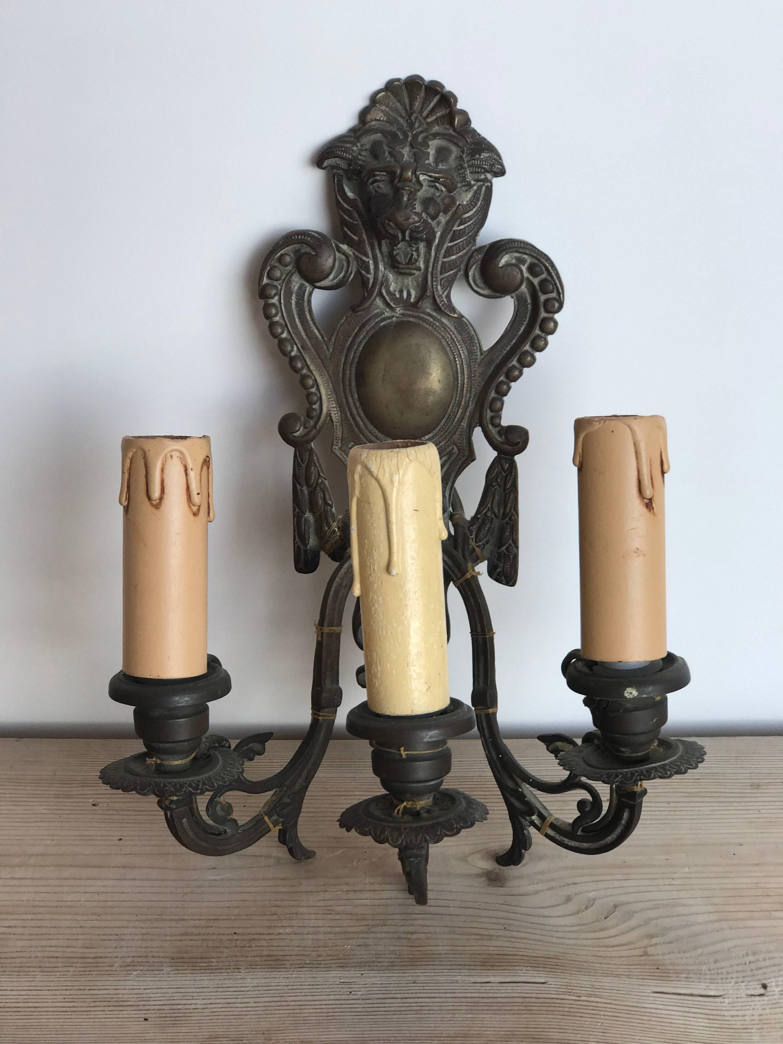 19th century French three-arm bronze sconces with lion heads.