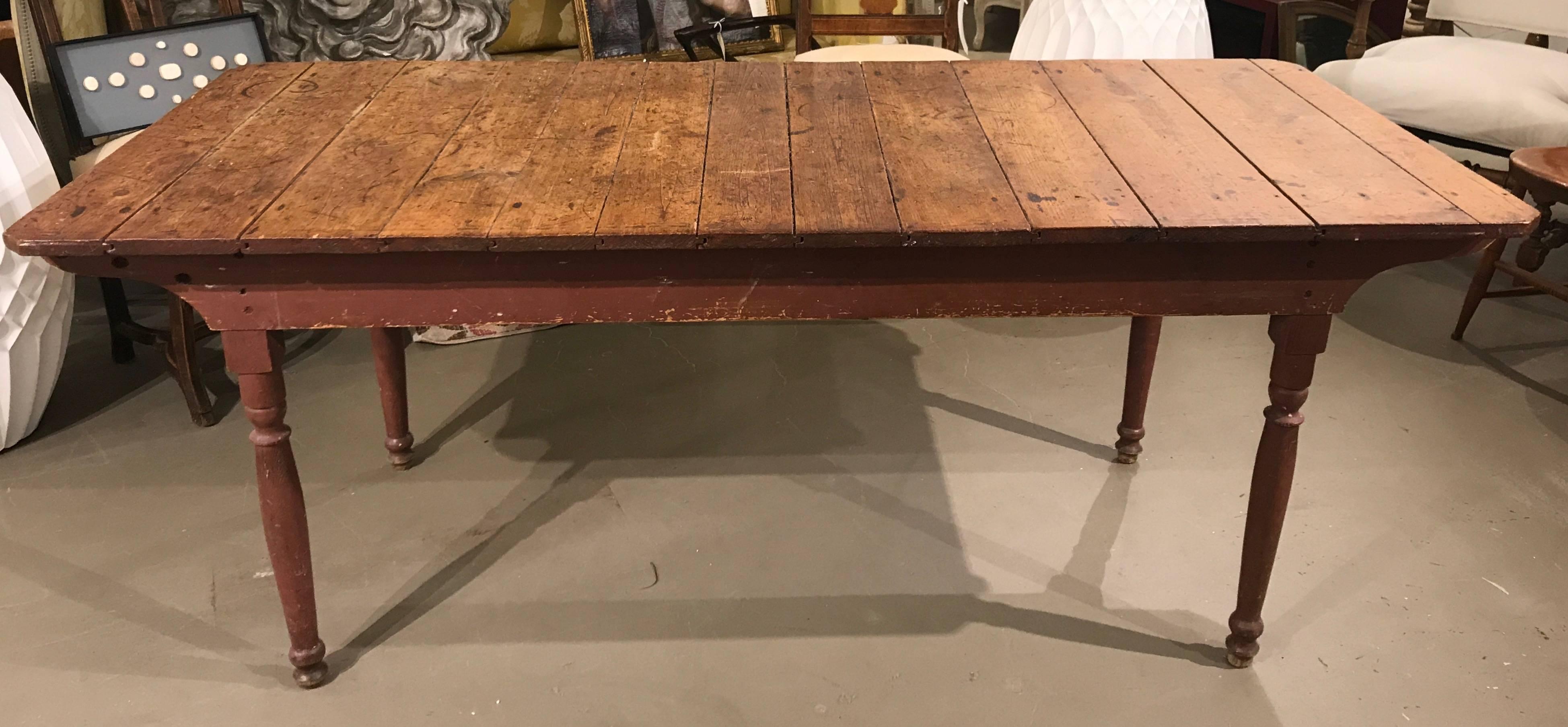 American country farm table with plank top and turned legs.