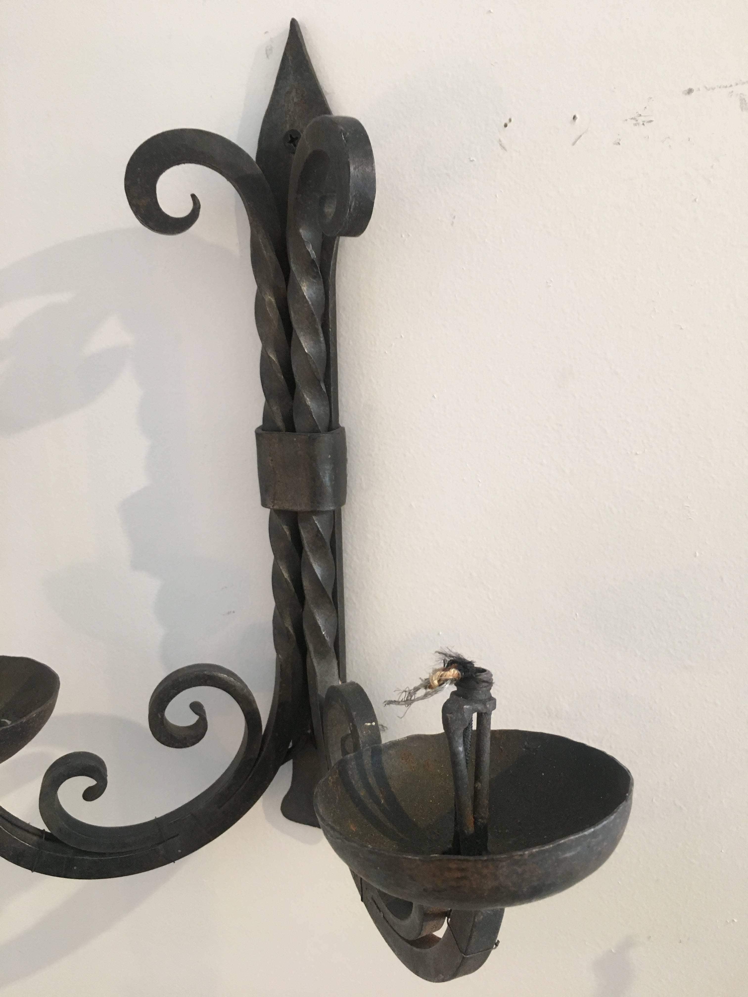 French two-arm wrought iron sconces.