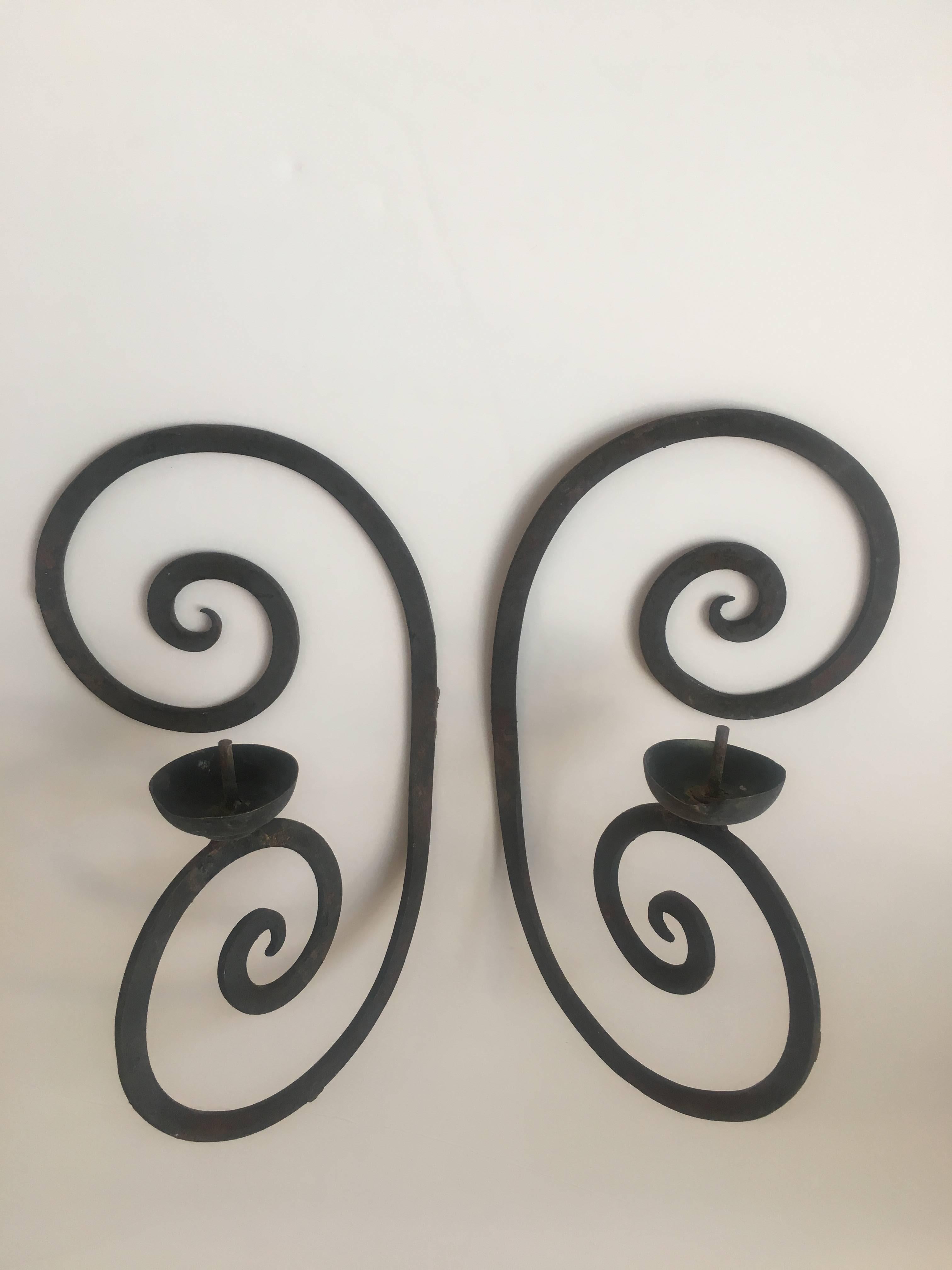 Pair of single arm wrought iron scroll back sconces with bobeche. Five pairs available.