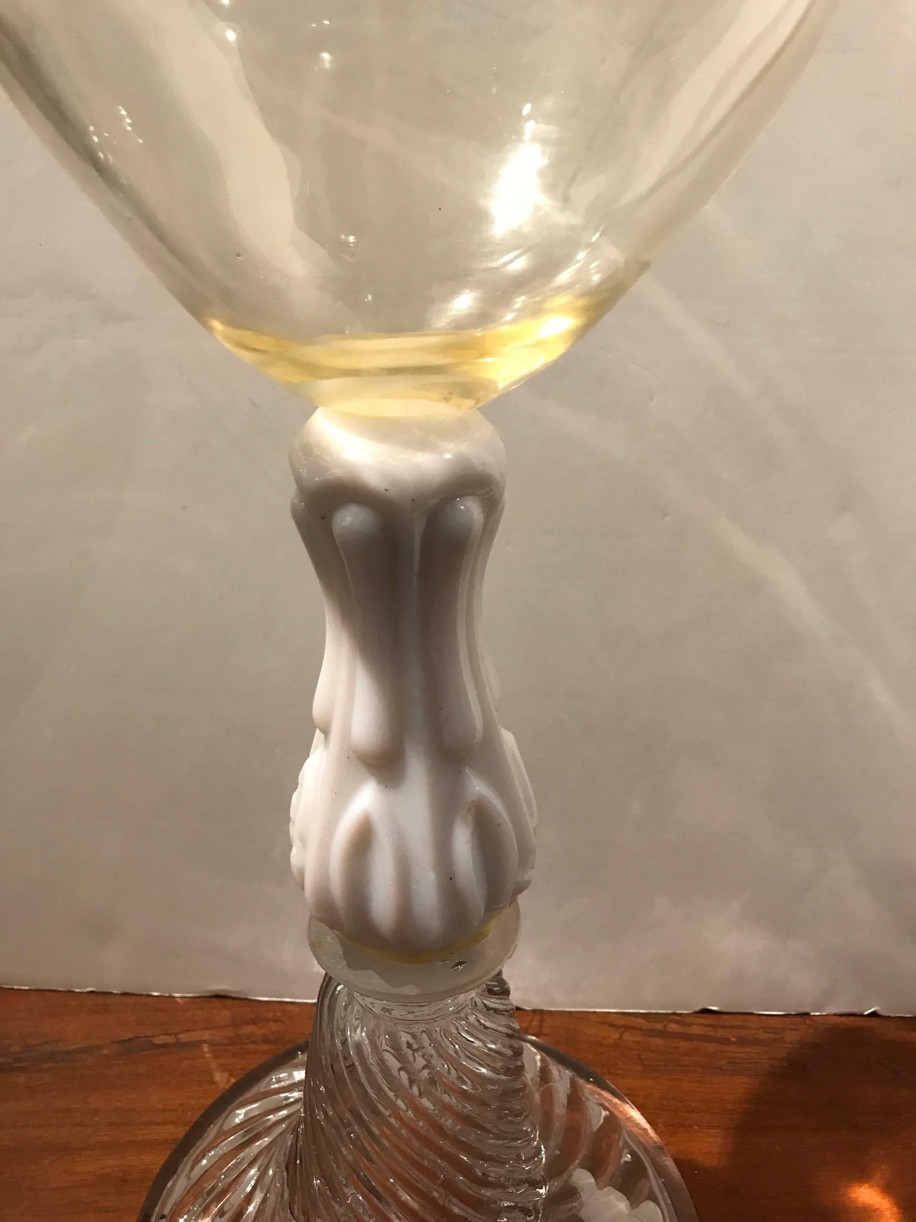 Glass oil lantern with opaline stem and swirled base.
 