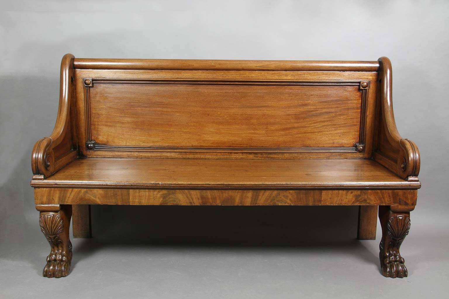 Rectangular paneled back flanked by scrolled paneled arms ending in lotus form carving raised on cabriole legs with stylized shell knees and paw feet.