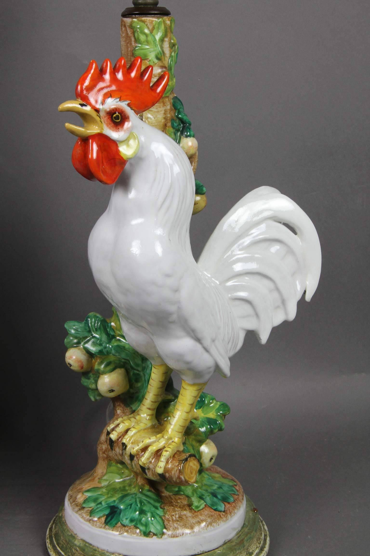 One with one rooster the other with two standing on branches on circular bases.
