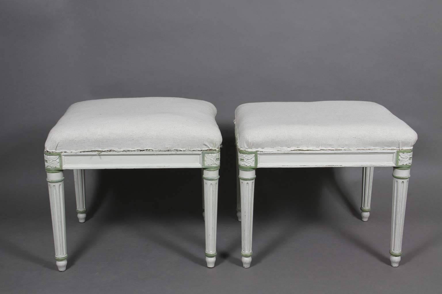 Each rectangular with light green accents raised on turned fluted tapered legs headed by paterae, toupie feet.