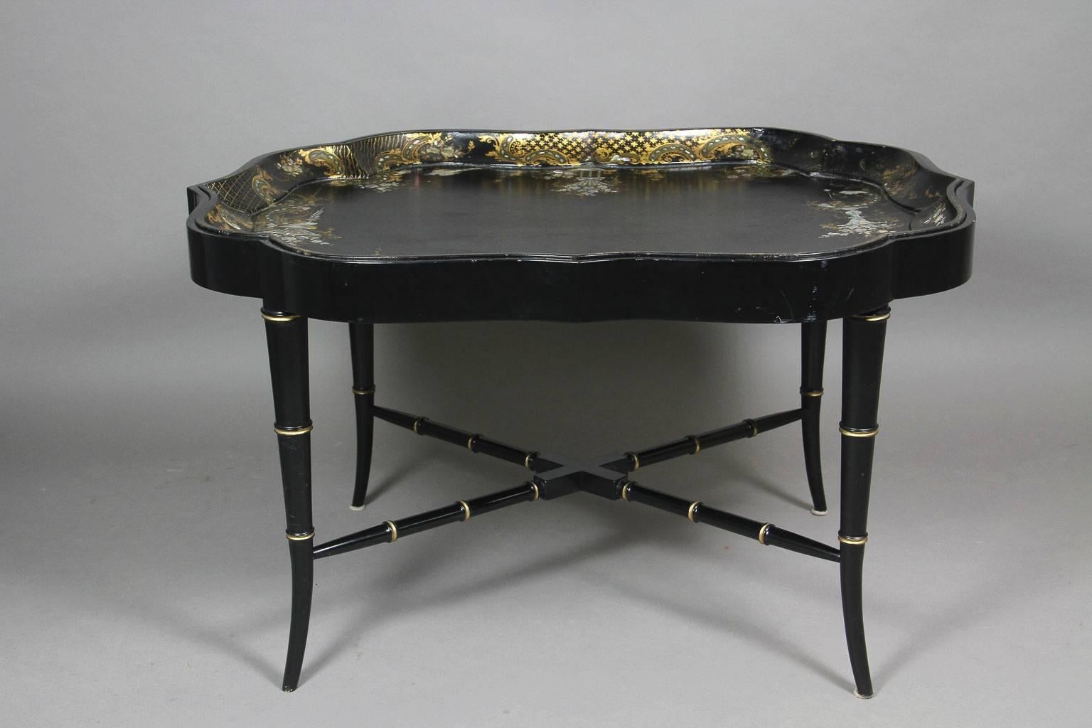 Shaped scallop tray decorated with urns and scrolls, flowers, ebonized base with faux bamboo legs and X form stretcher. Ex Rockefeller, Taubman collection.