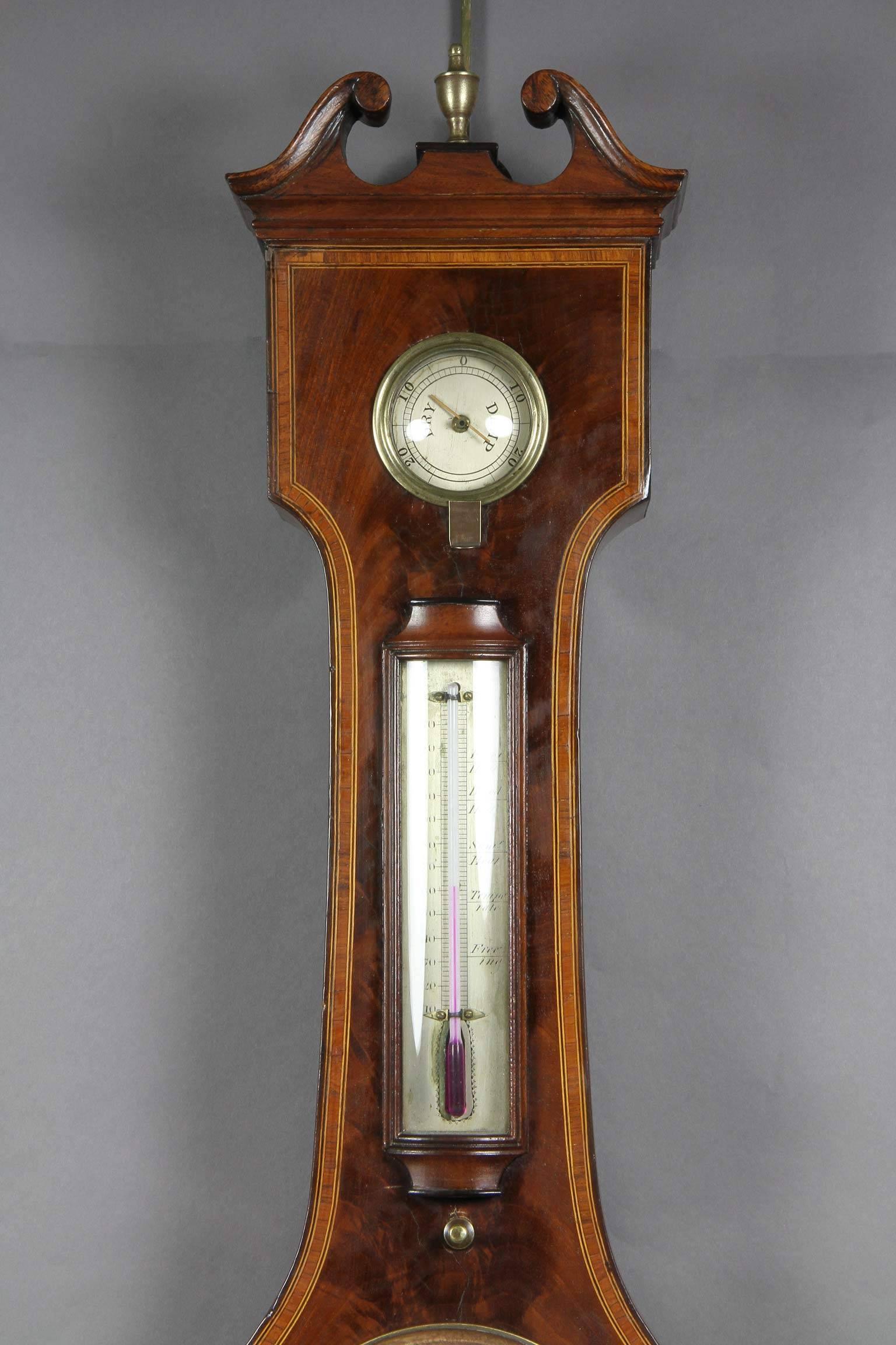 Broken arch top over a hydrometer dial and thermometer, clock, barometer dial and level.