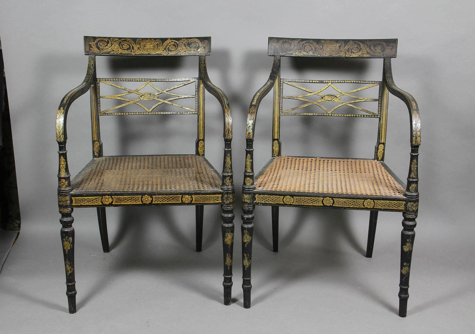 Each with a tablet crest decorated with scrolling arabesques over a pierced horizontal trellis splat, down swept arms joining a caned seat raised on circular tapered legs.