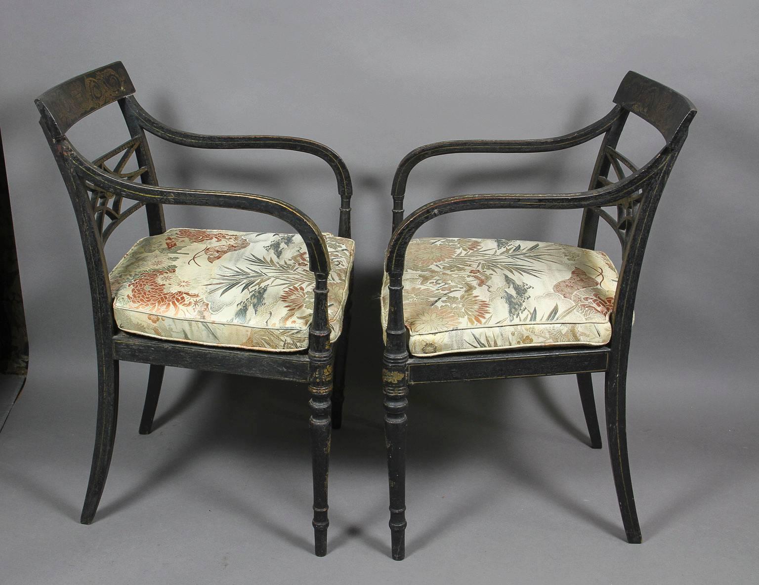 English Pair of Regency Ebonized and Gilded Armchairs