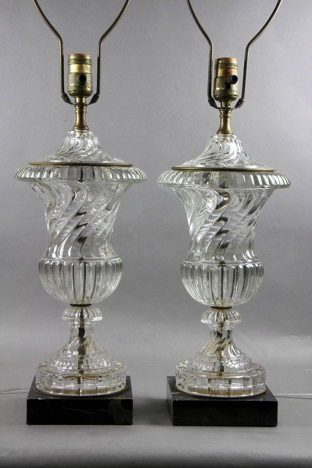 Each with acanthus cast finial, urn shaped swirled glass vase with gilt metal accents on a conforming sole and ending on a square portoro marble base. Newly wired.