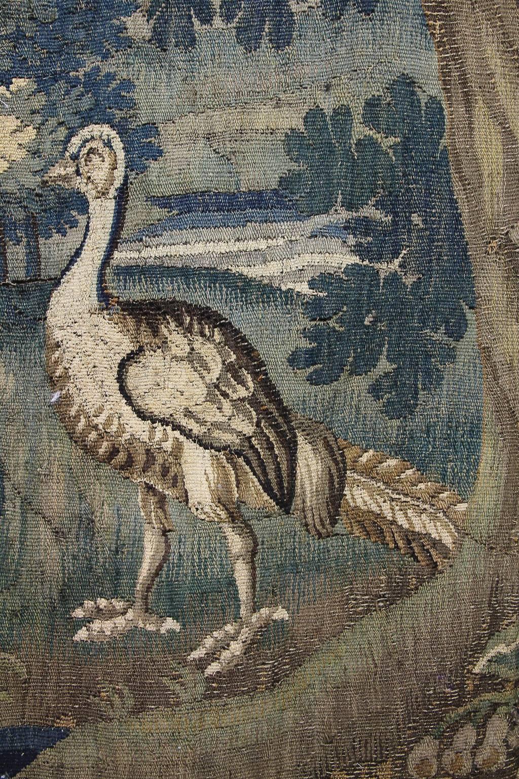 Originally part of a much bigger tapestry, the scene depicting two birds in a landscape.