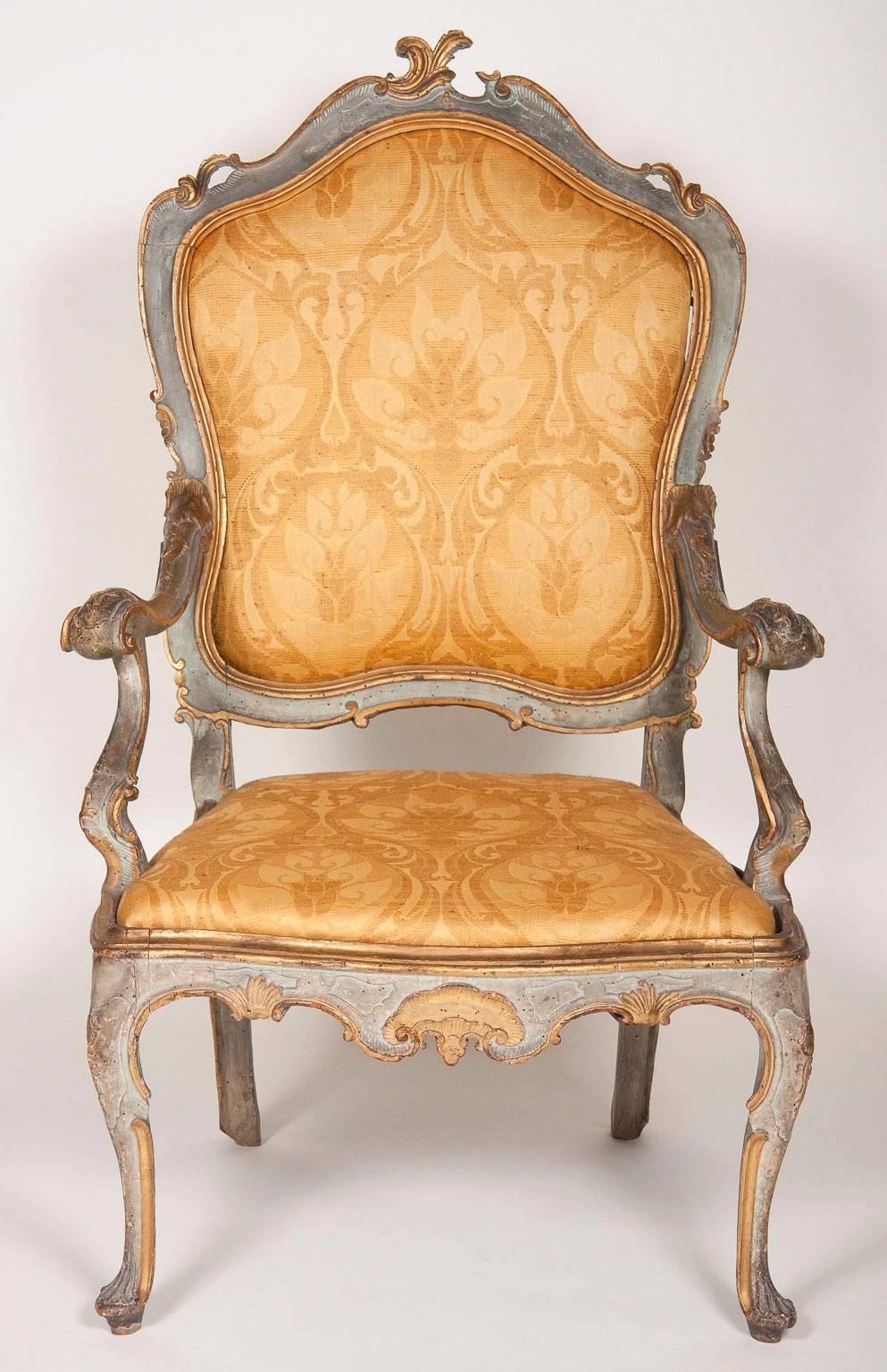Arched backs and bowed seat set in a wonderfully carved frame with outscrolled arms and raised on cabriole legs.