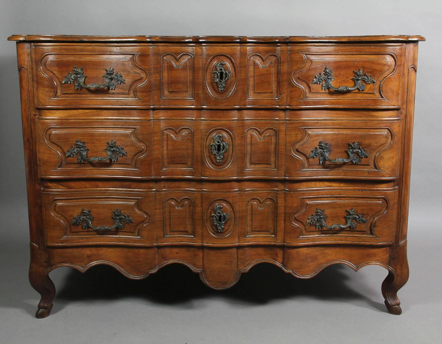 Shaped serpentine top over three conforming paneled drawers, shaped apron, ending on cabriole legs and hoof feet. In unusually fine condition.