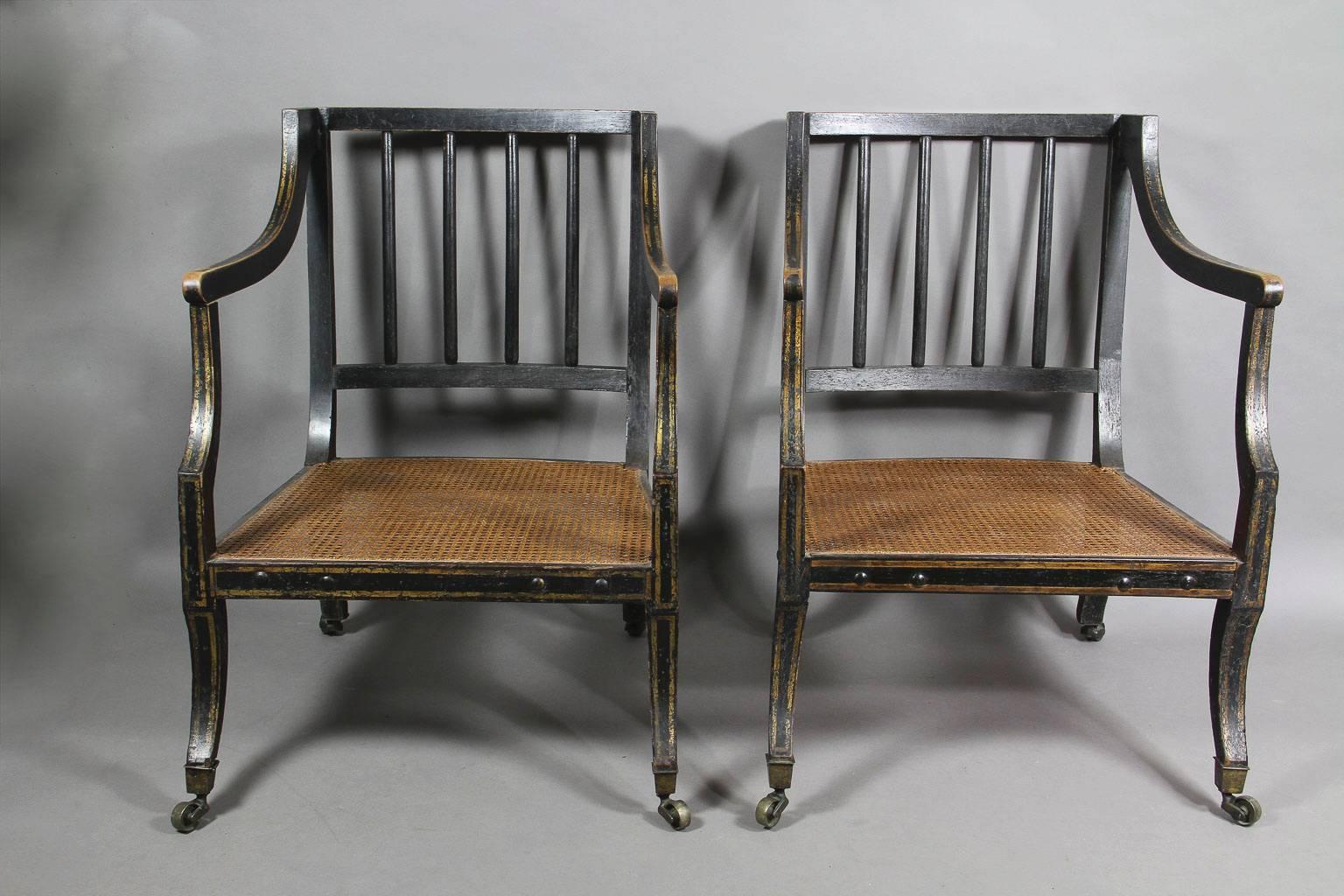 Pair of Regency Ebonized and Gilded Caned Armchairs 1