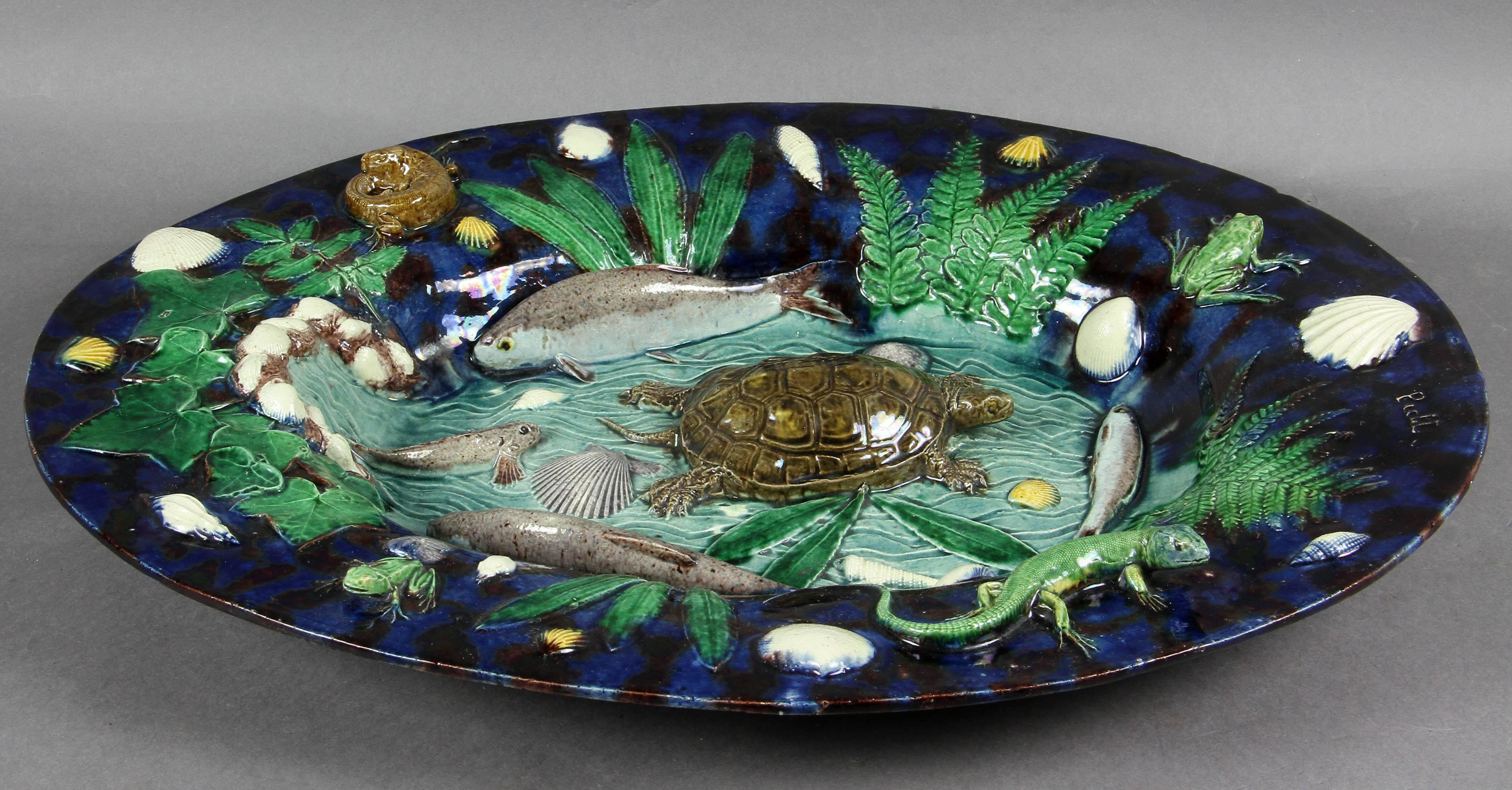 Wonderfully colored with turtle, fish, frogs and salamanders etc. signed on rim.