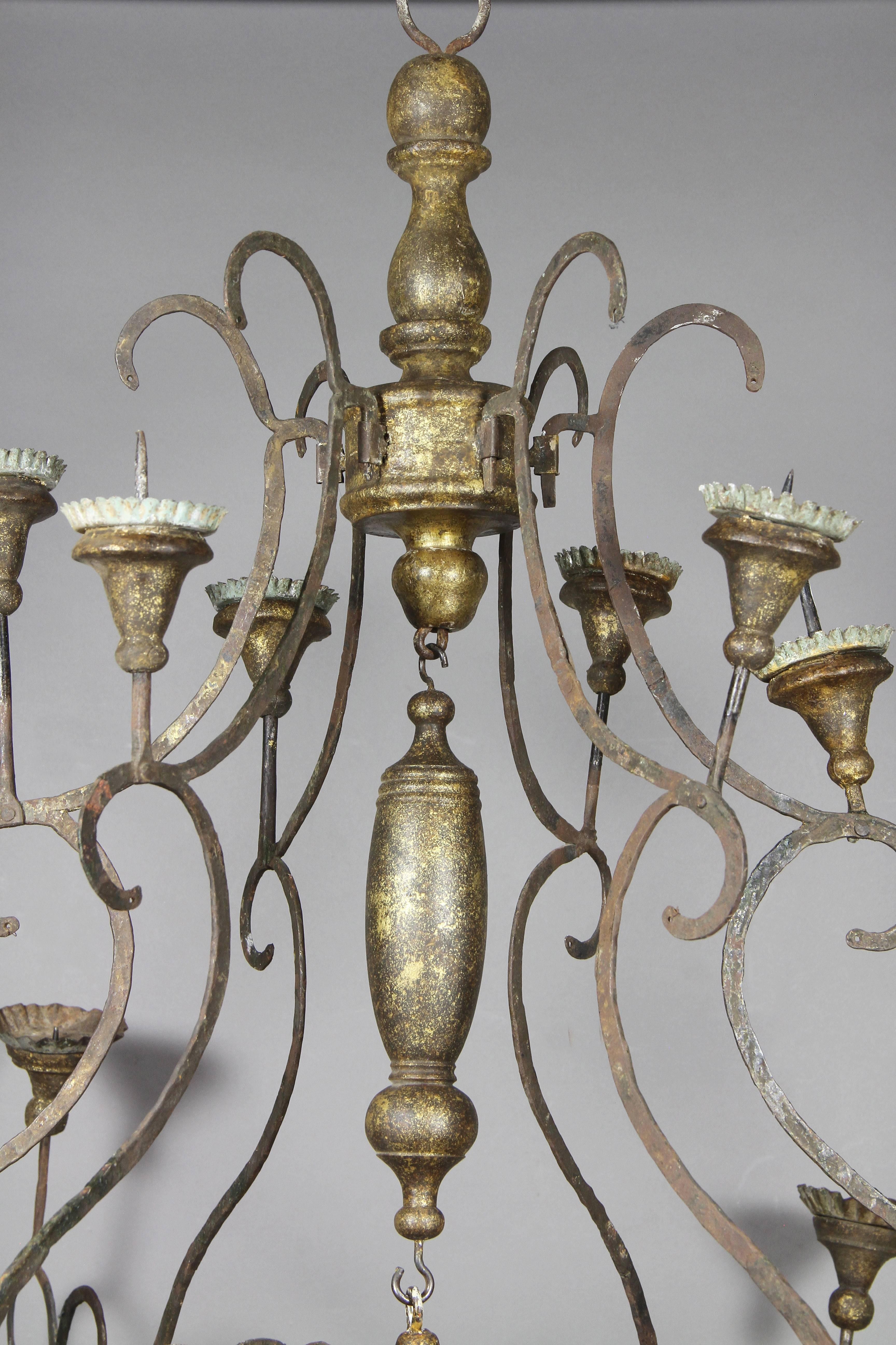 Two-tier with 12 candleholders, flattened wrought iron arms. Not wired.