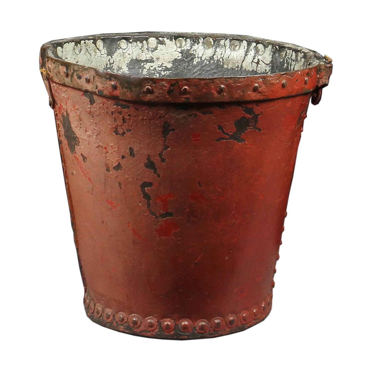 Georgian red leather fire bucket. Circular tapered form with royal crest.