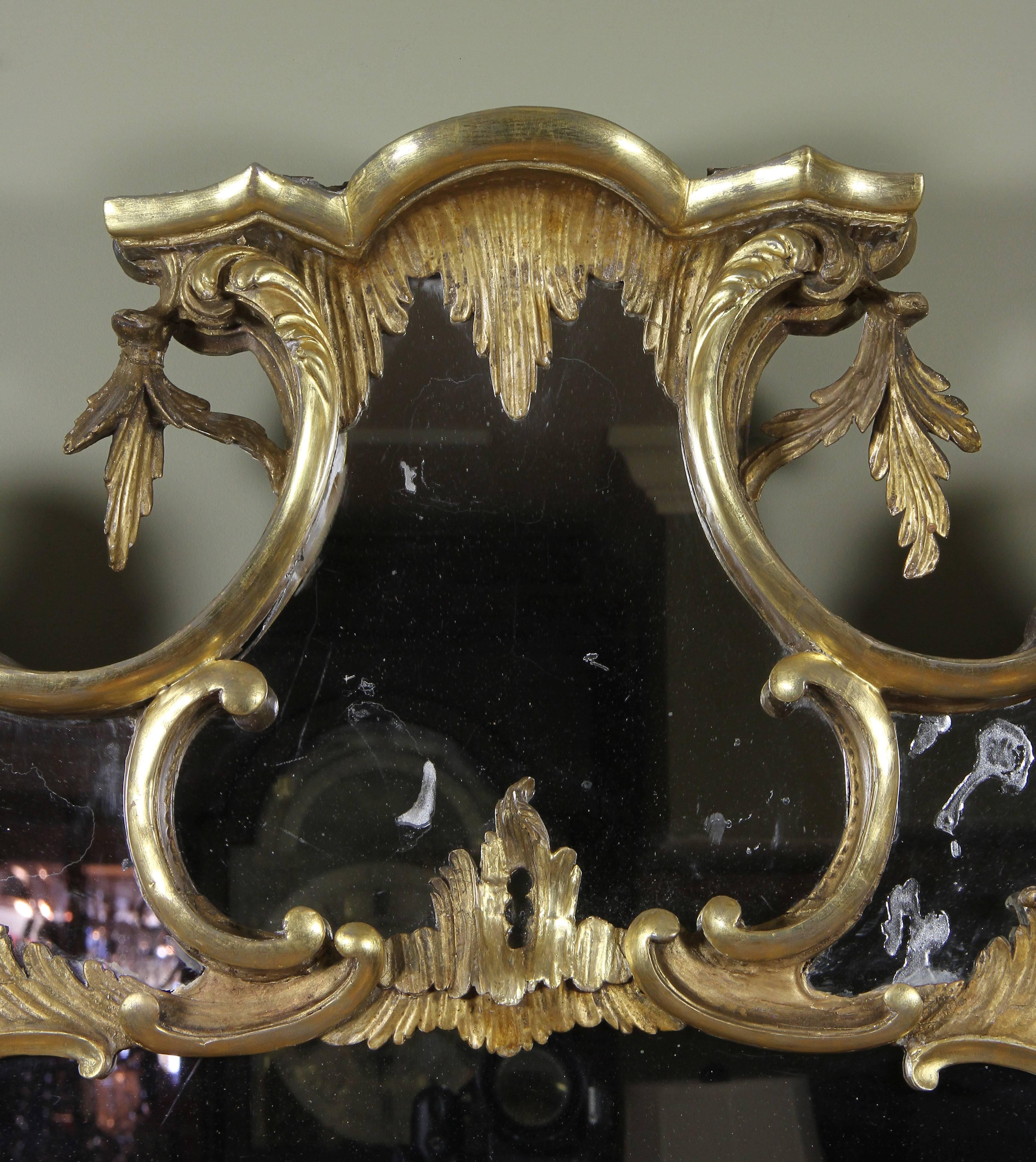 Mirror plate set within a scroll carved inner and outer frame decorated with C-scrolls, rocaille and cabochons. Original glass. Provenance: Park Avenue, New York apartment.