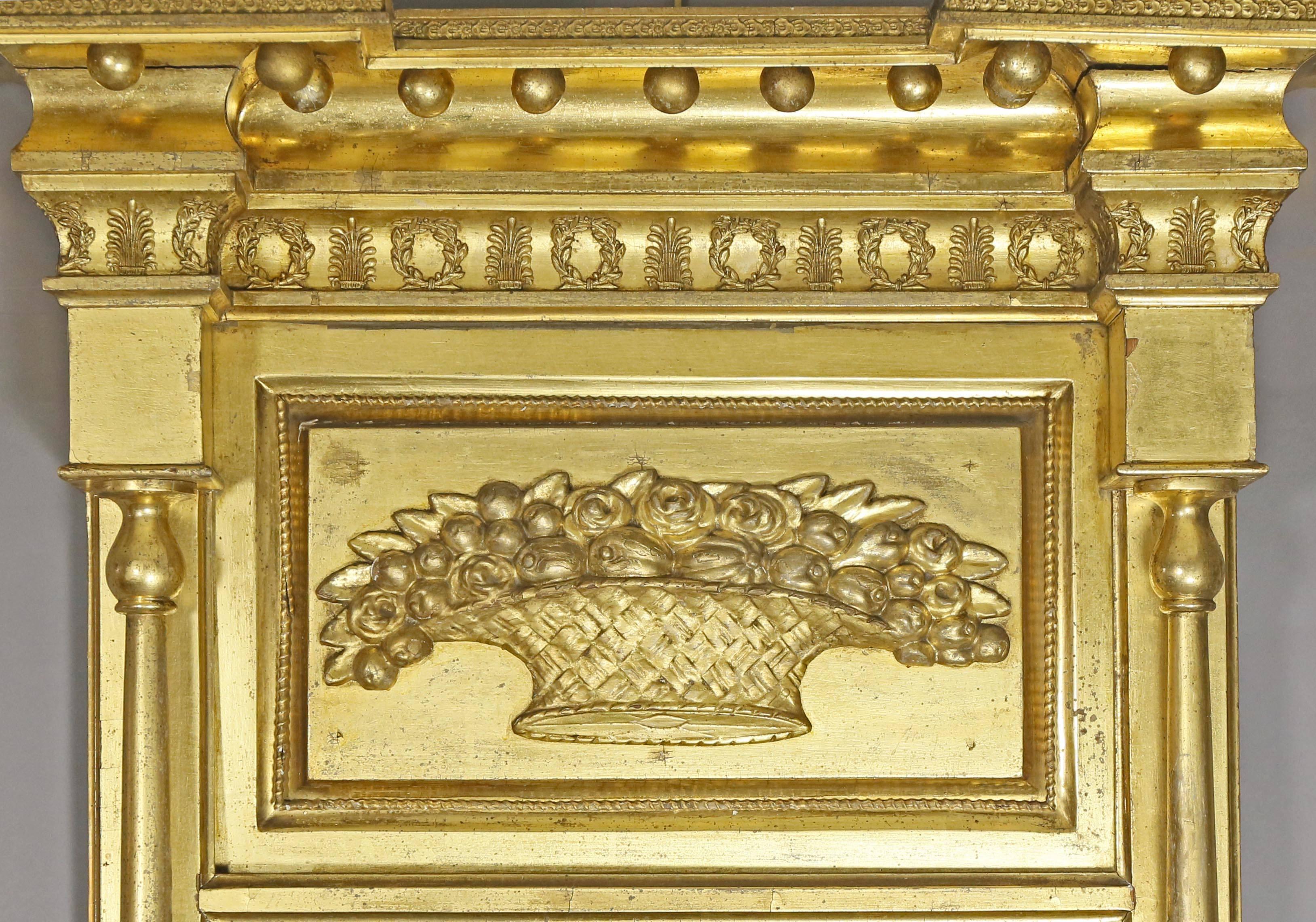 Original gilding with overhanging cornice with sperules over a Samuel McIntire basket of fruit and mirror plate flanked by columns.