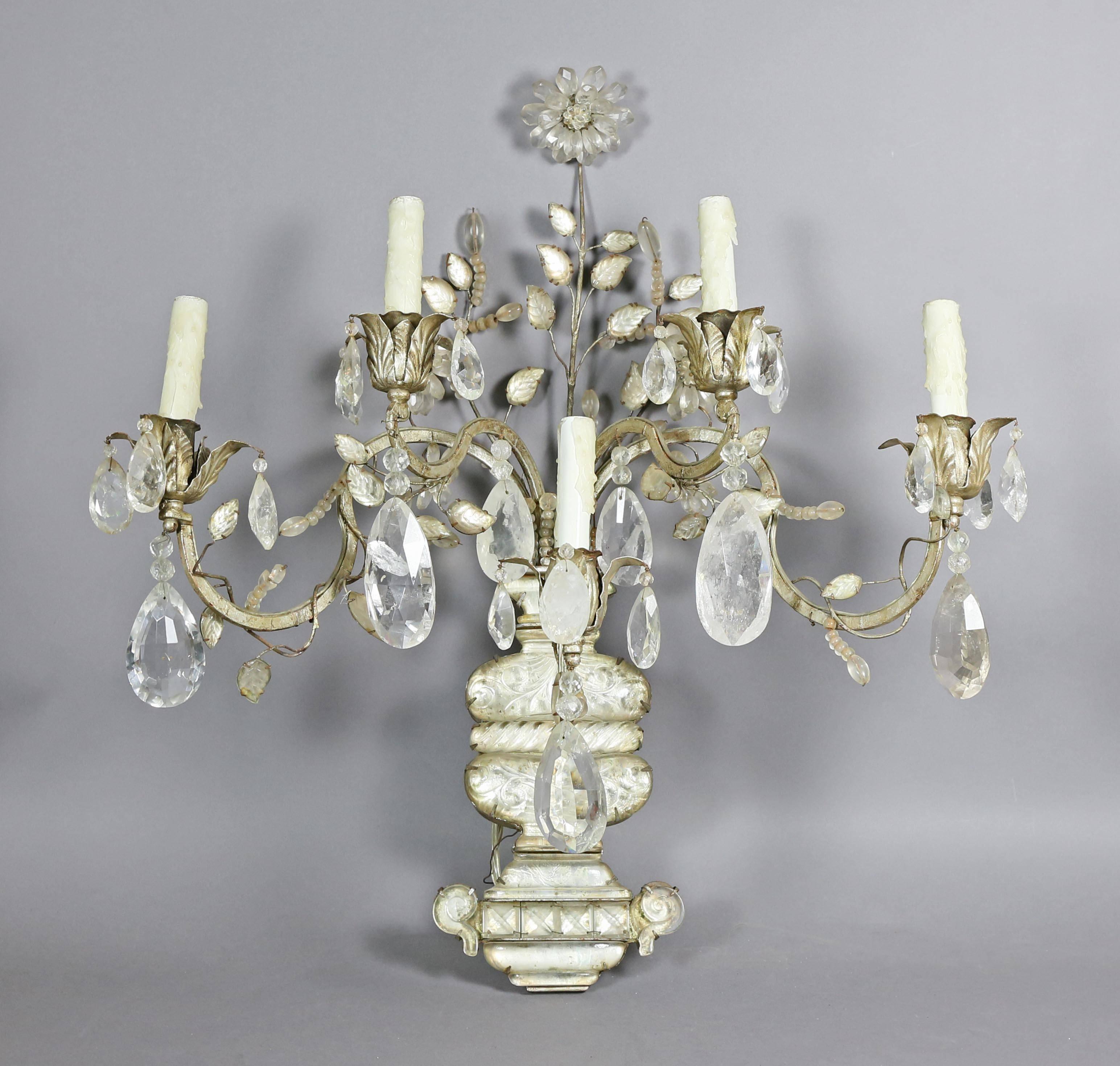 Each in the form of a flowered filled urn with five scrolled candle branches entwined with vines and large pendants. Provenance; Sothebys New York Important French Furniture, May 25th 2000, Lot 231, sold for 23,750 dollars.