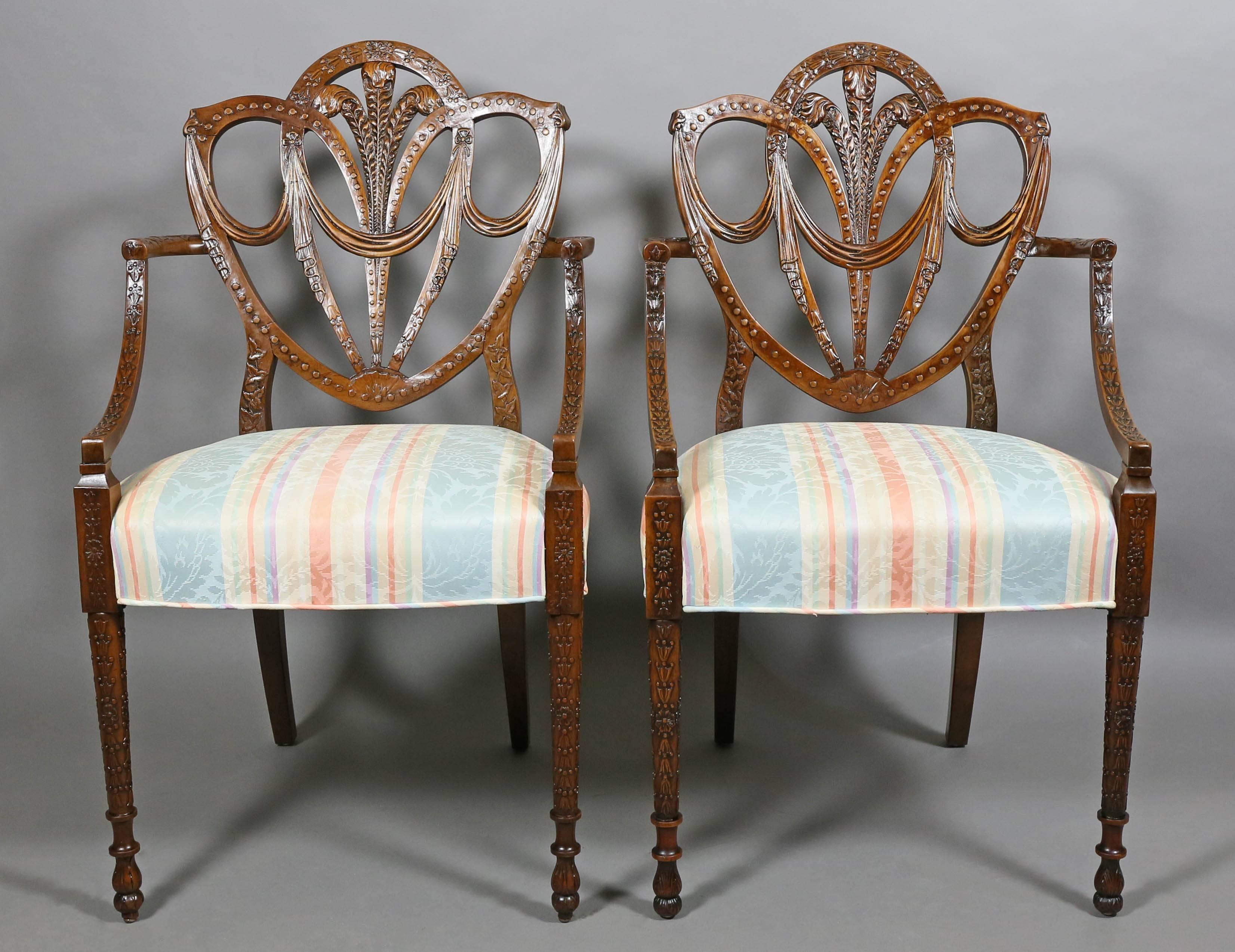 Each with shield back with Prince of Wales plumes, carved with bellflowers and swags, bowed upholstered seat, raised on circular tapered legs. Provenance; Crane Estate.