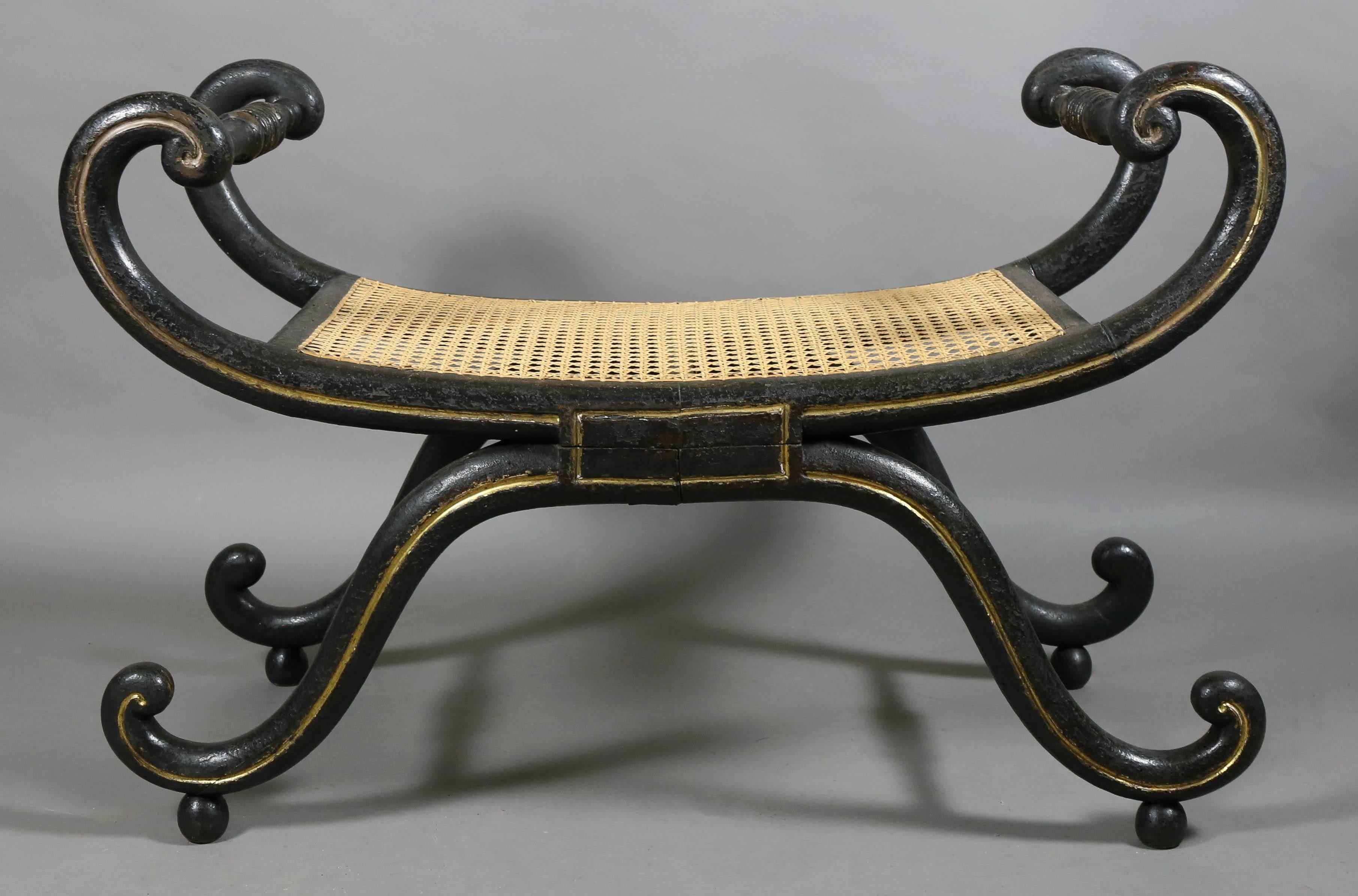 With a caned seat and gilded detailing.