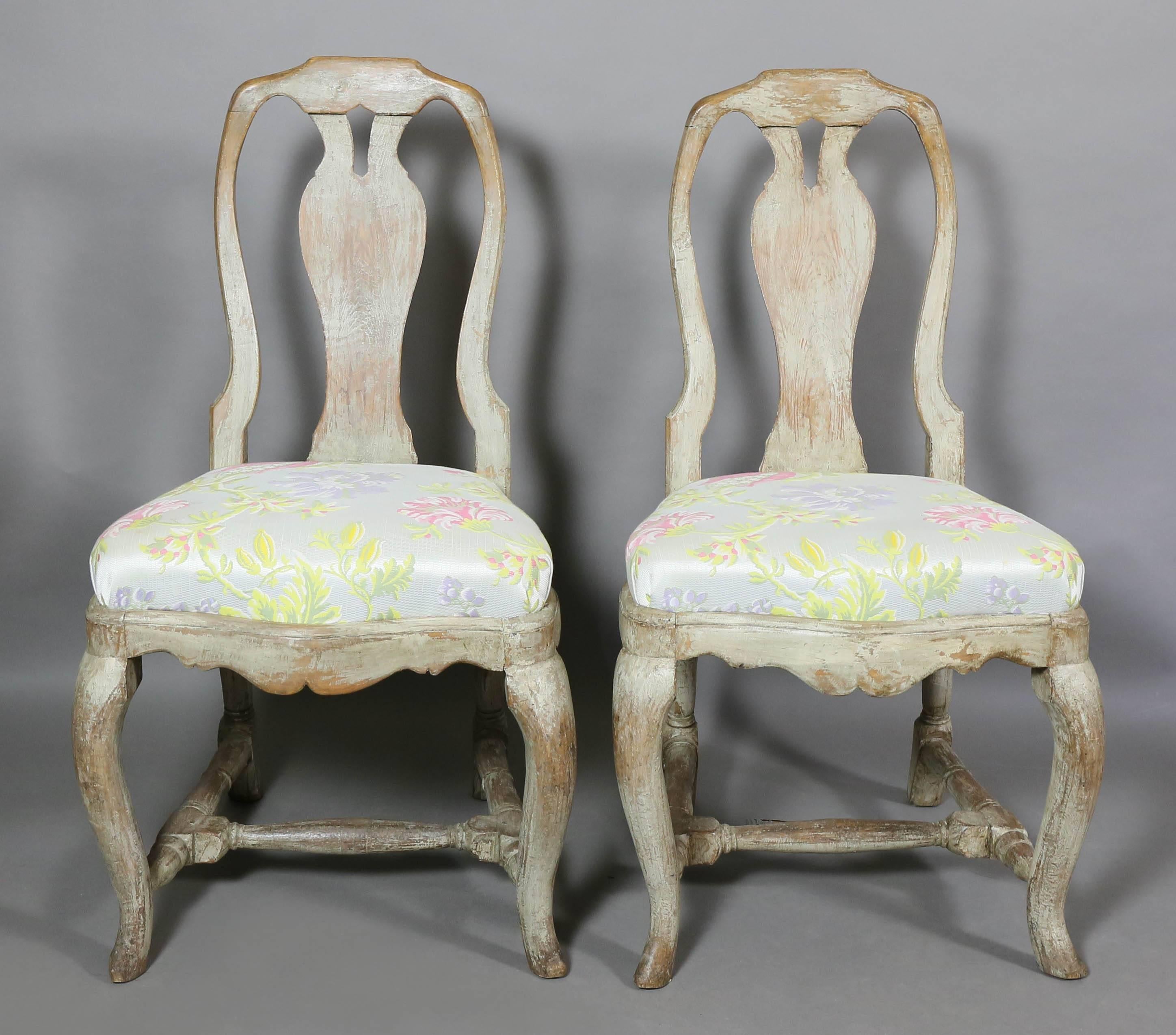 Each with an arched back with central vasiform splat, serpentine silk drop in upholstered seat raised on cabriole legs with turned H form stretchers, pad feet.