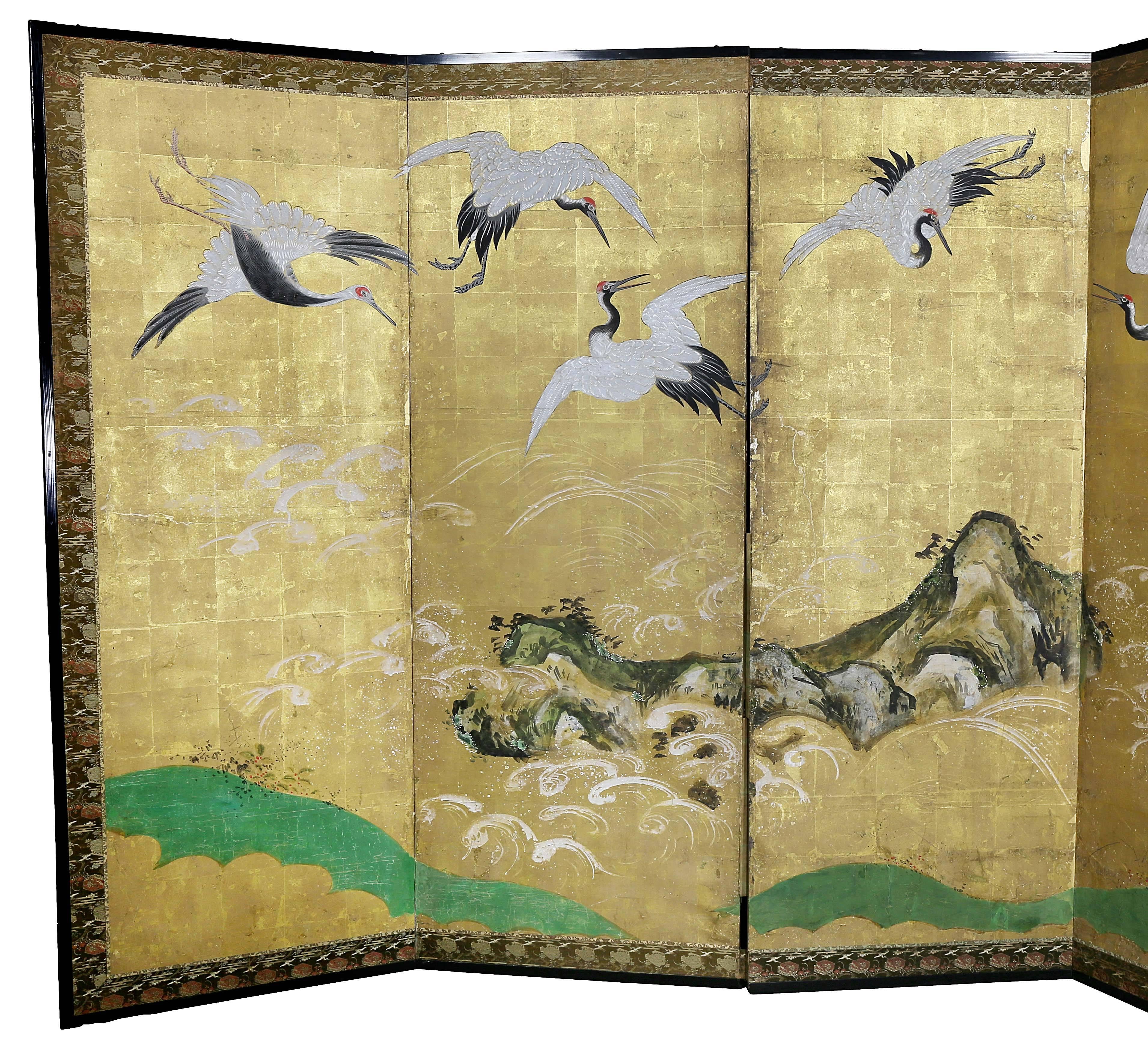 Scene with cranes painted with watercolors on square panels of gold leaf, fabric and lacquered wood frame, Meiji period.