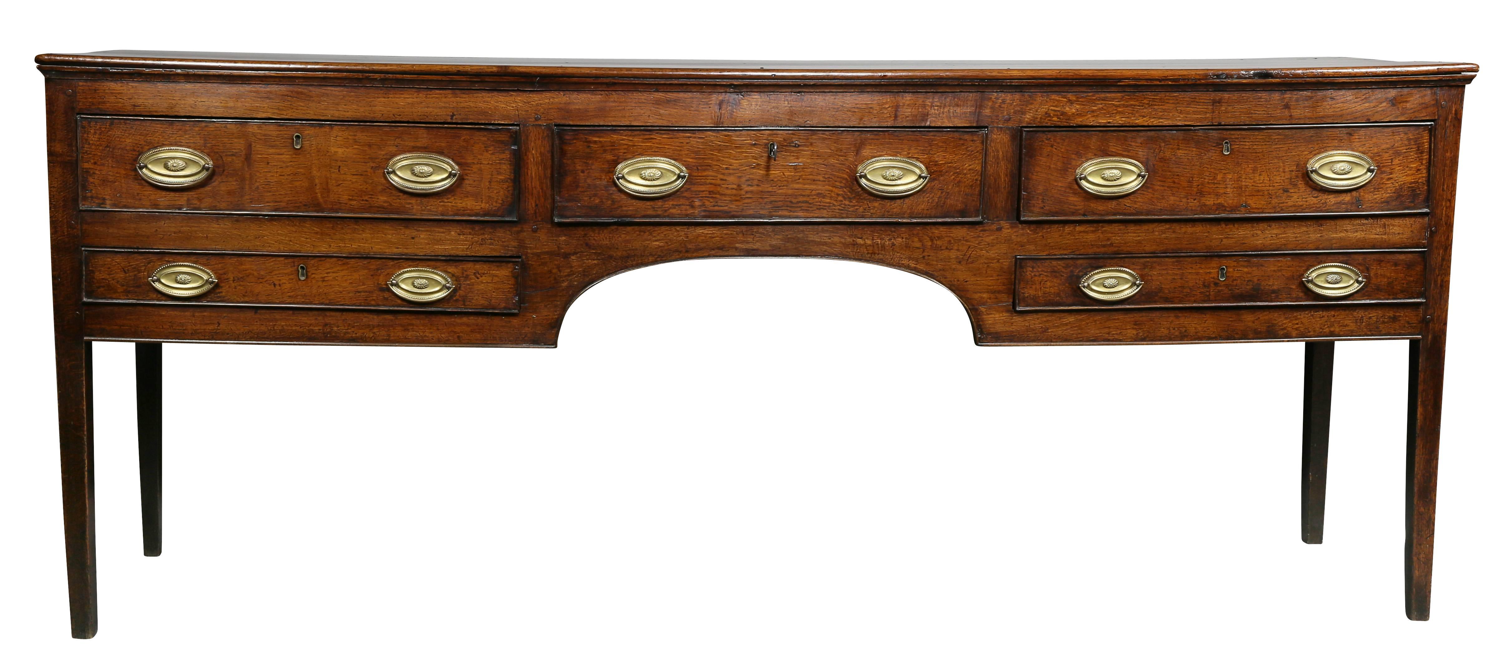 Rectangular top over a central drawer flanked by two drawers, raised on square legs. Panelled ends.