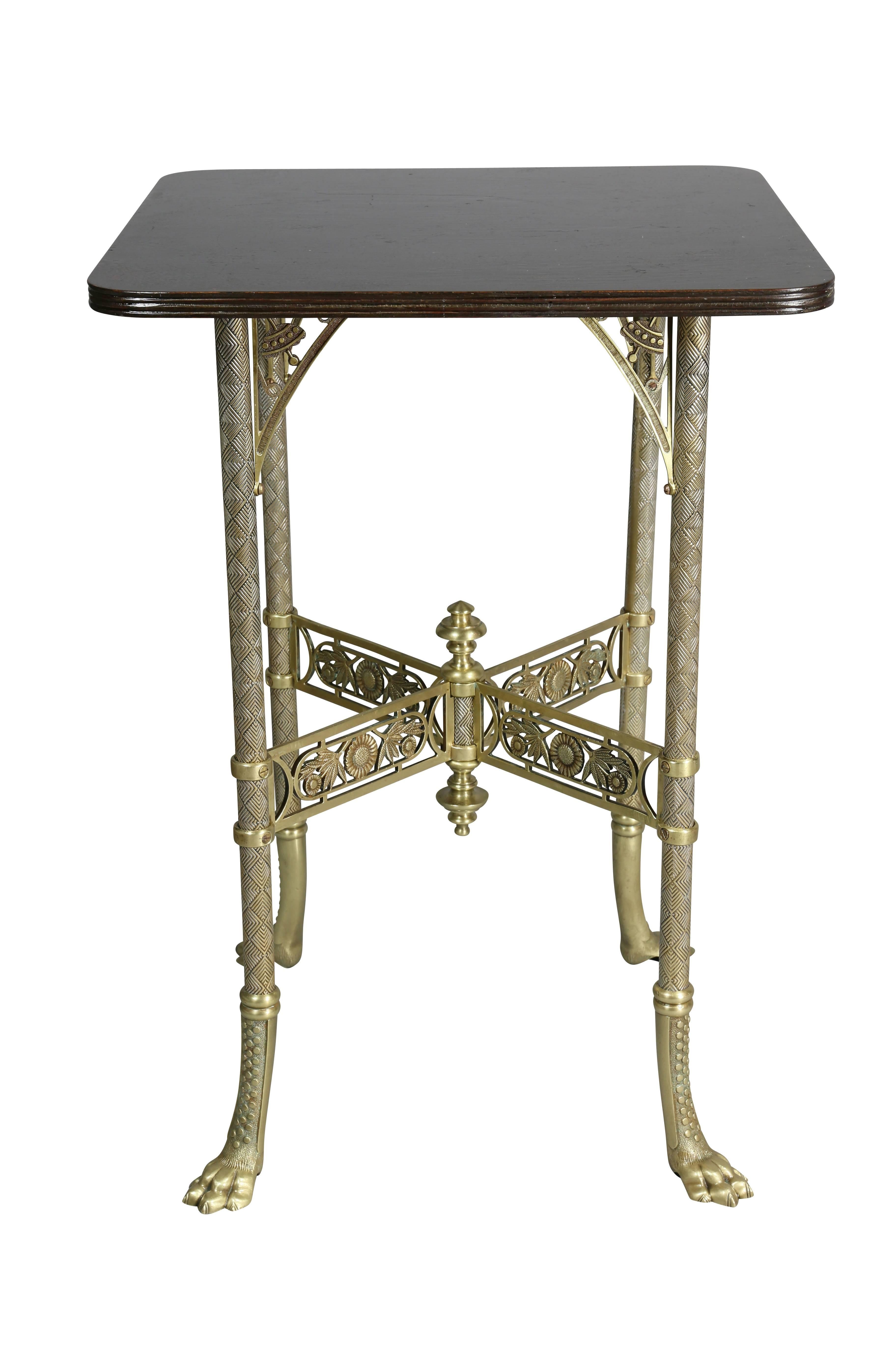 With square wood top with reeded edge over a base with spandrels with decoration in the form of a top, crosshatched tubular legs and X form stretcher with pierced decoration and chrysanthemums, paw feet.