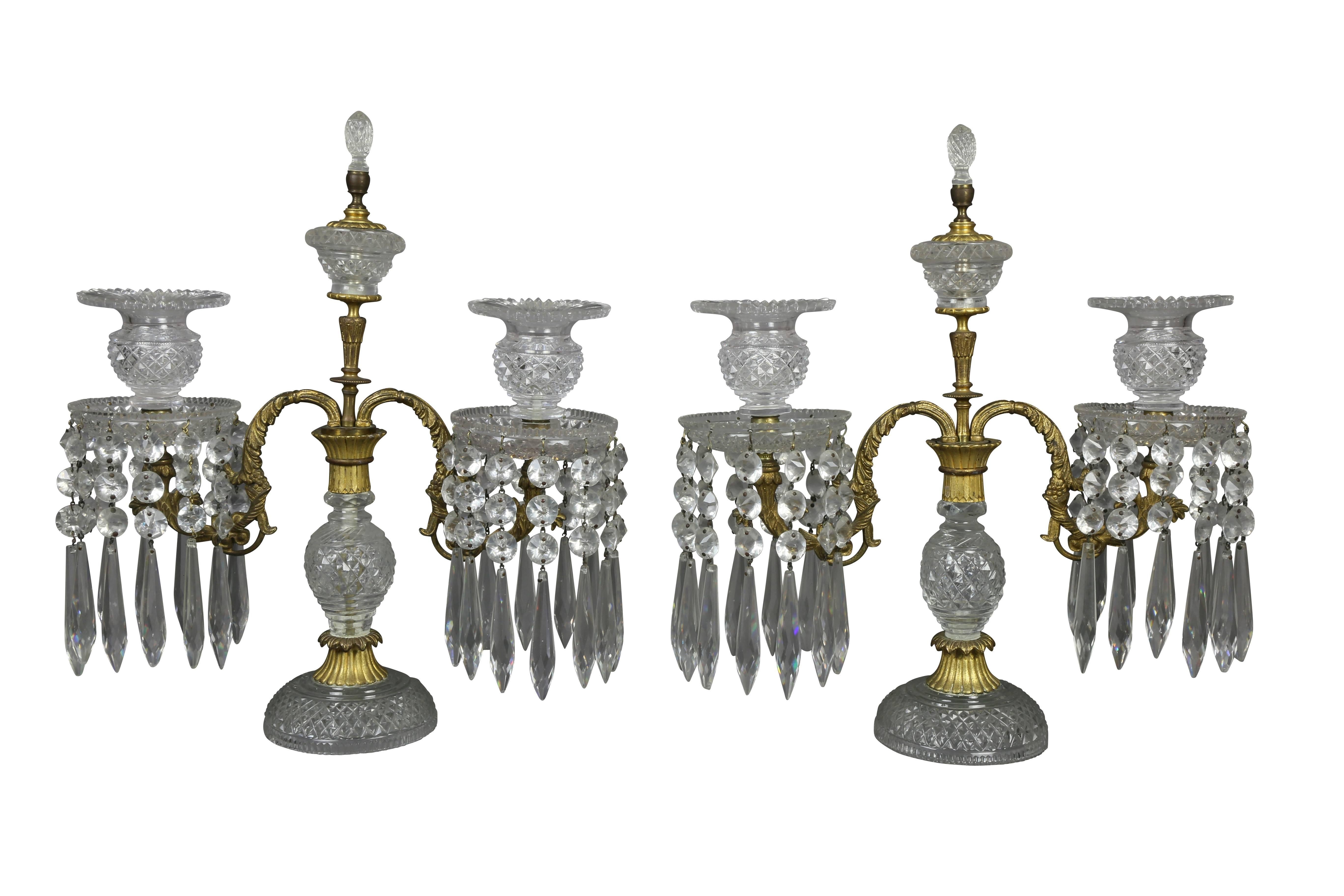 Each with two arms with suspended prisms, central glass finial, raised on cut-glass support and circular foot.