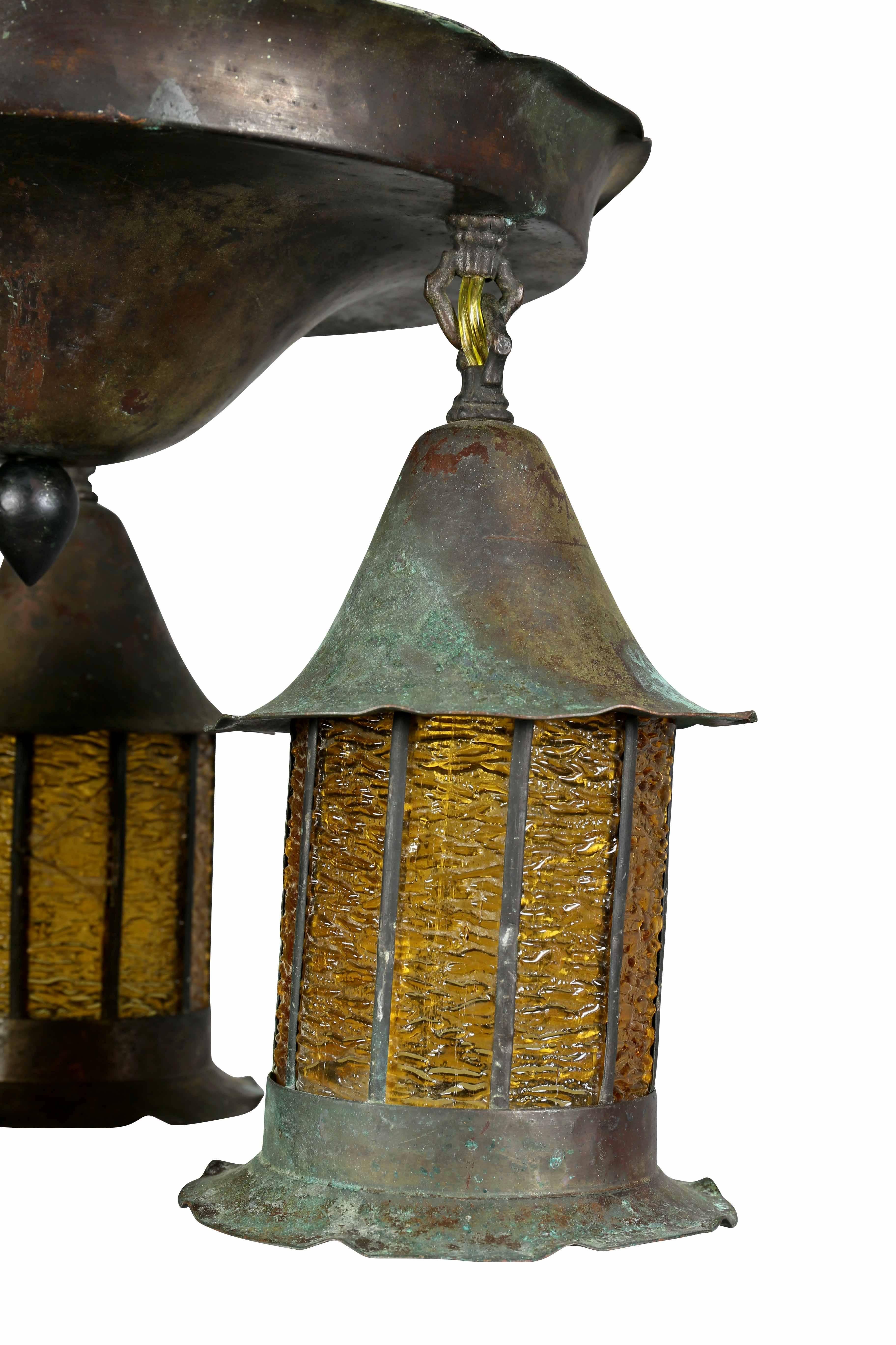 With domed flush fitting cap with three suspended lamps each with amber rippled glass. Rewired.