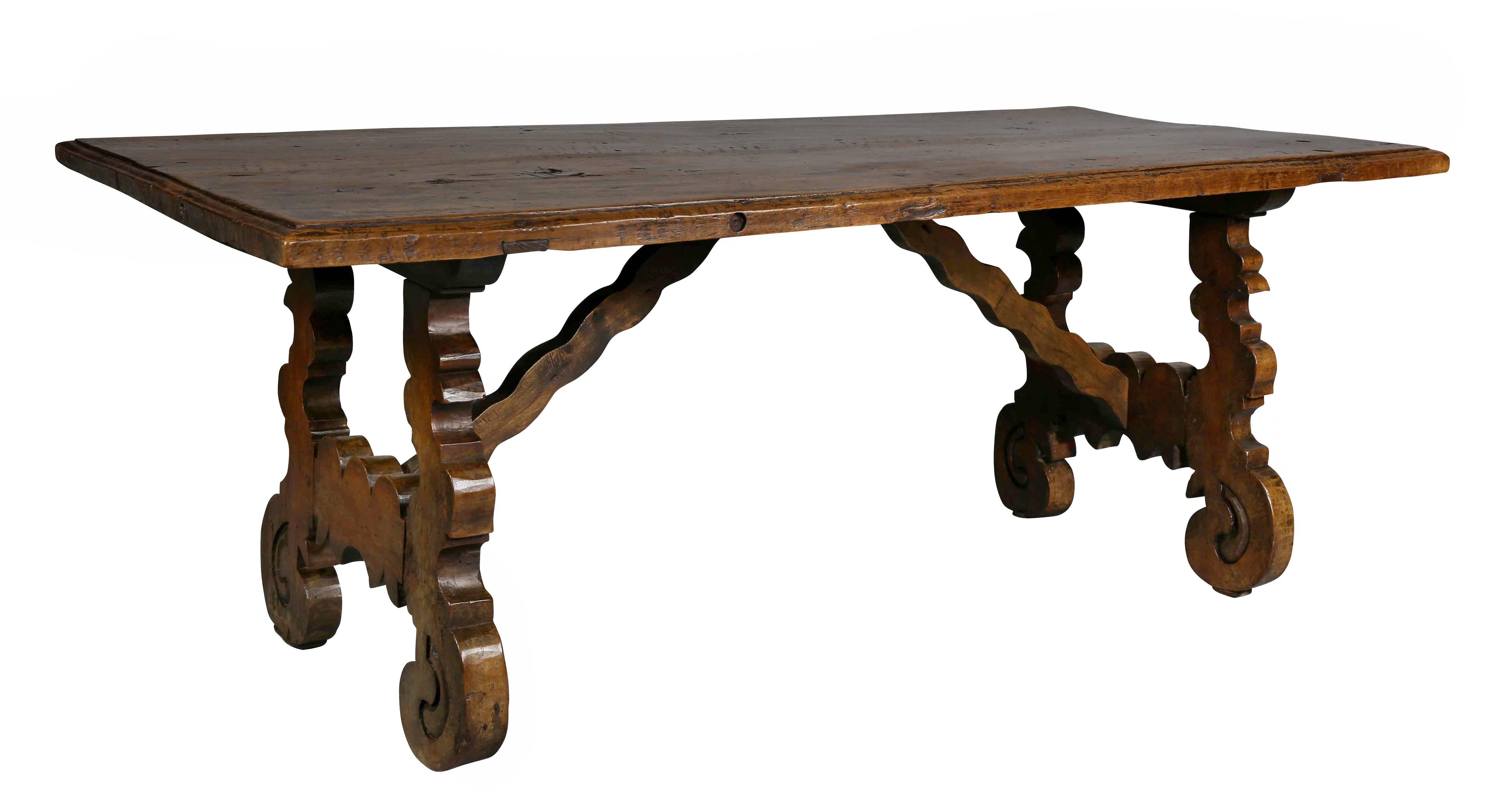 Rectangular top with "s" scroll form legs with wood stretcher.