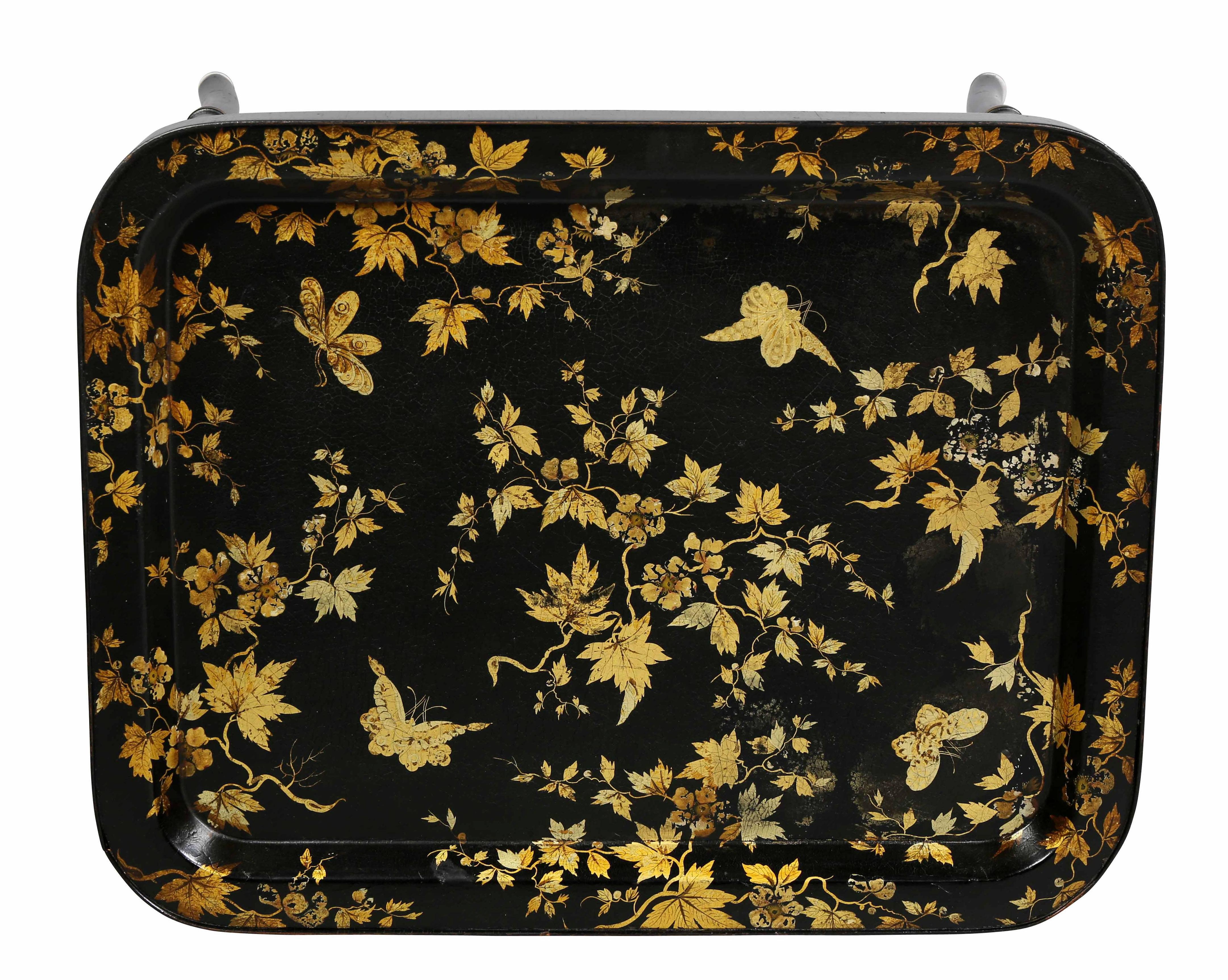 Rectangular tray with gold floral decoration raised on bamboo turned legs with X stretcher.