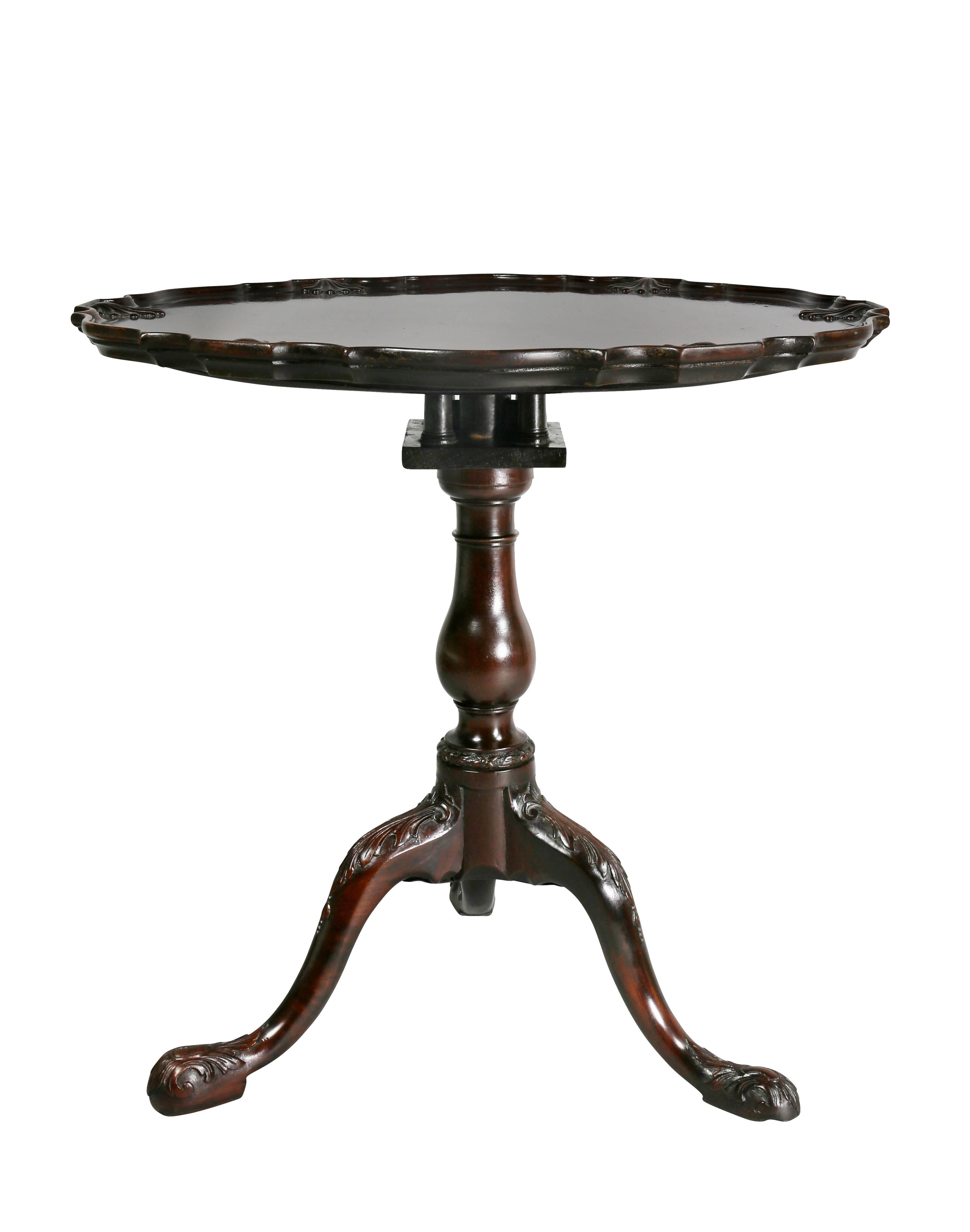 Circular tilt top with shell carved edge, birdcage below and turned support joining three cabriole legs with carved knees, carved pad feet.

Folded dimensions: 44.25" H x 29.63" W x 7" D.