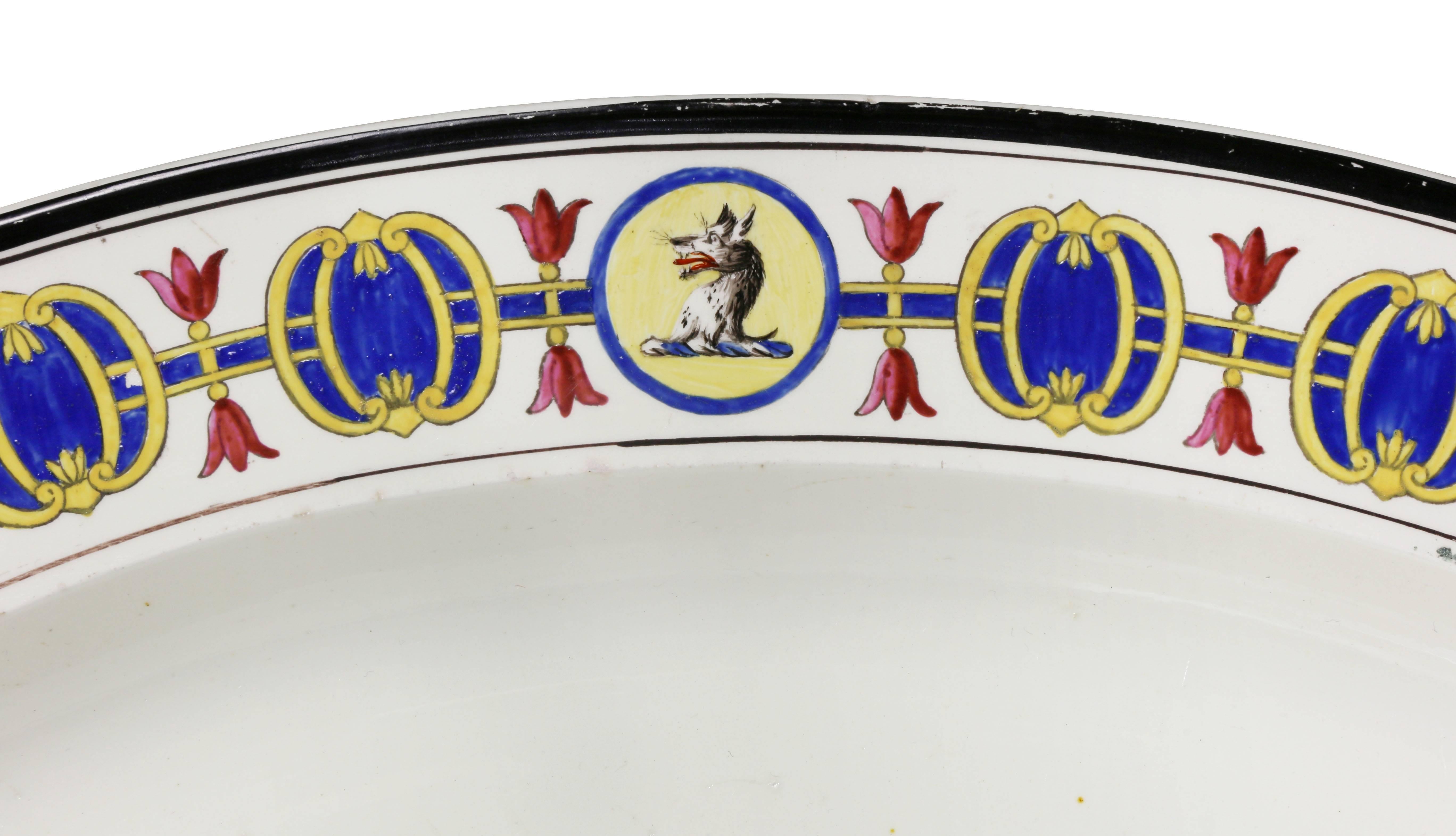 Oval with decorated border and armorial crest. Marked Wedgwood. With Moulton Family crest.