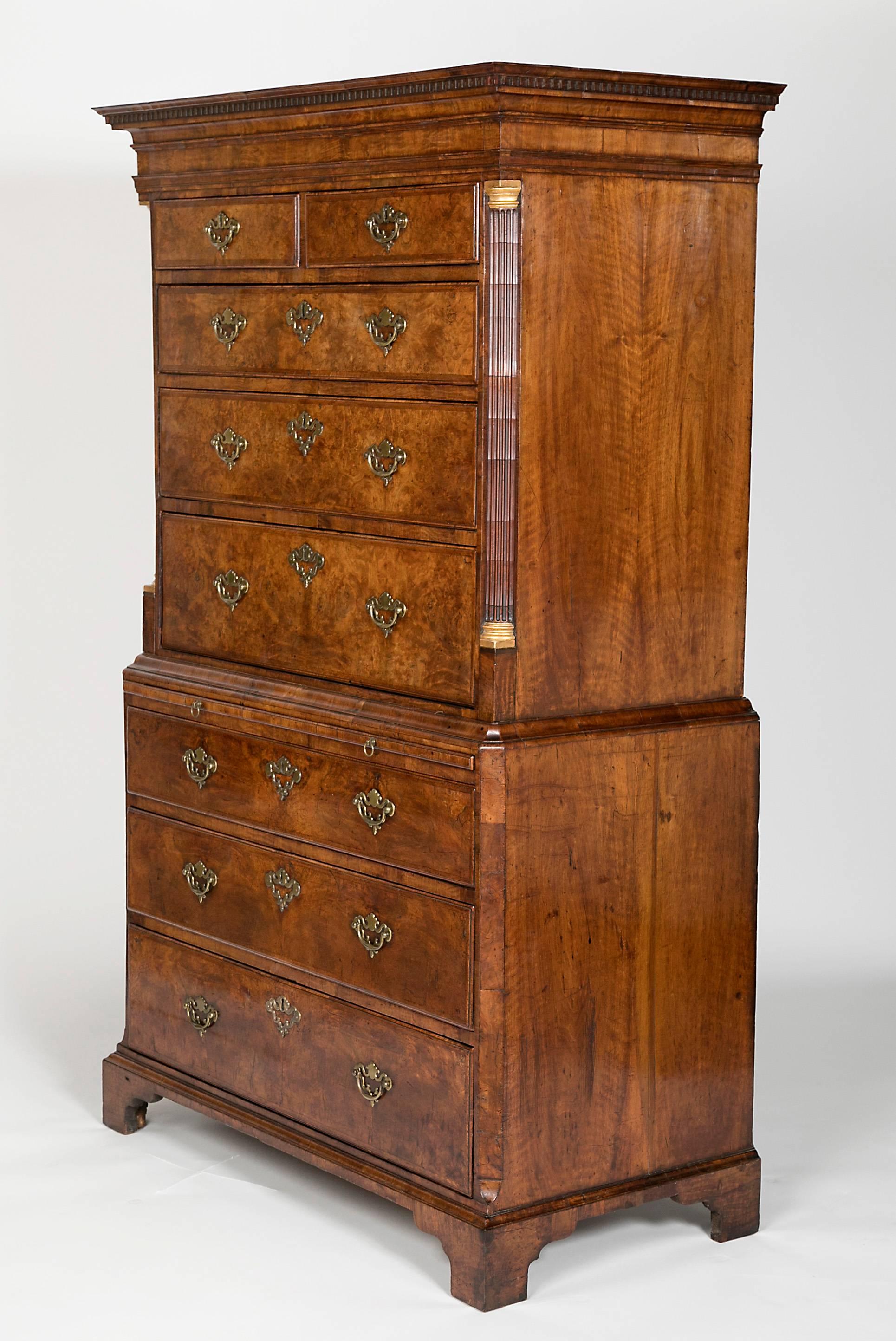 With dentilled cornice and two over three graduated drawers and flanked by reeded quarter columns, the base with a brushing slide and three drawers, top and bottom with original handles, bracket feet. Provenance; Koger estate.