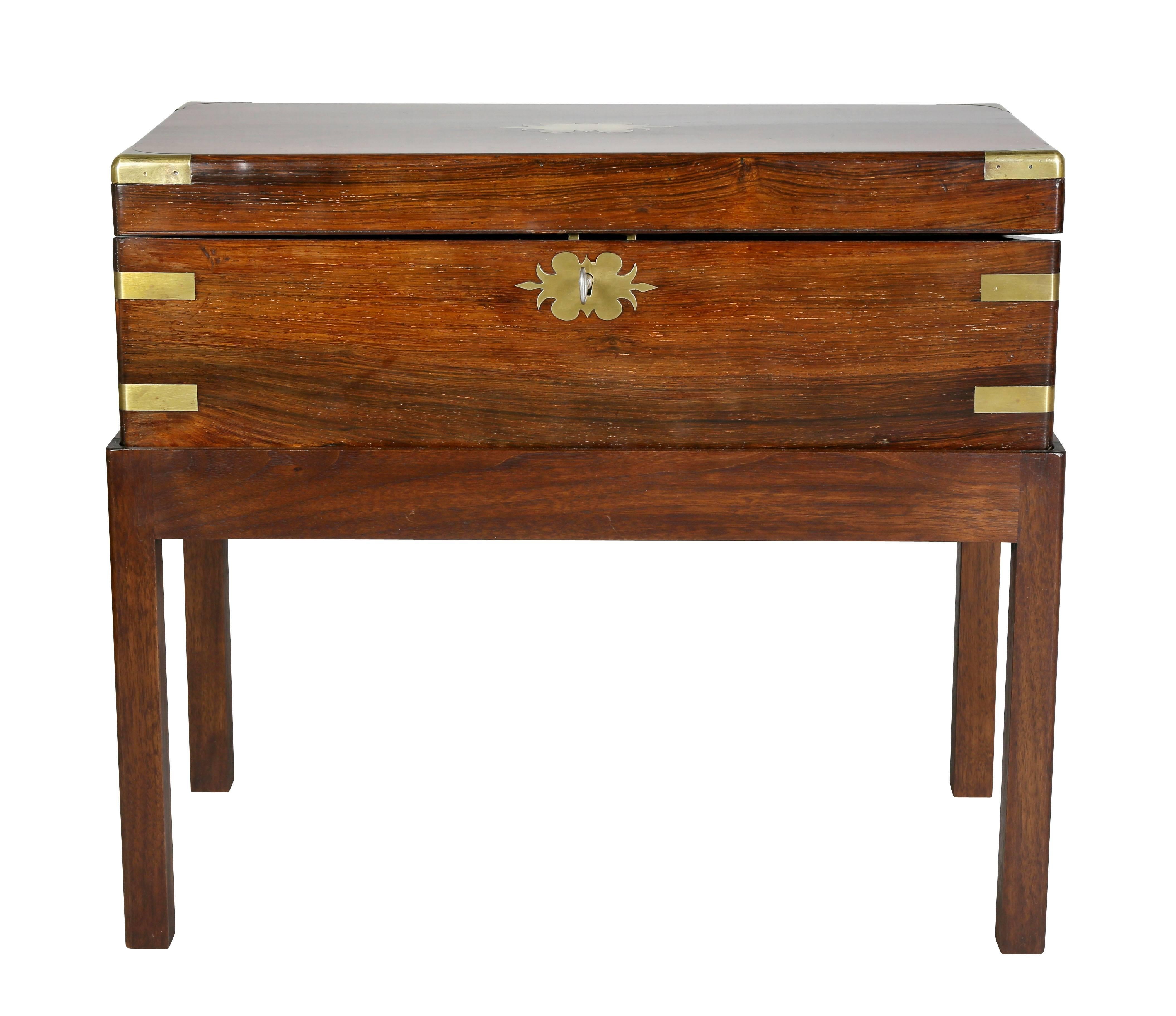 Hinged top with brass inlay opening to a desk with fitted compartments, included and found in a secret compartment a receipt from Baring Brothers, London for 550 British pounds, dated 1854 for the ship Faneuil Hall of Boston from Captain Bangs.