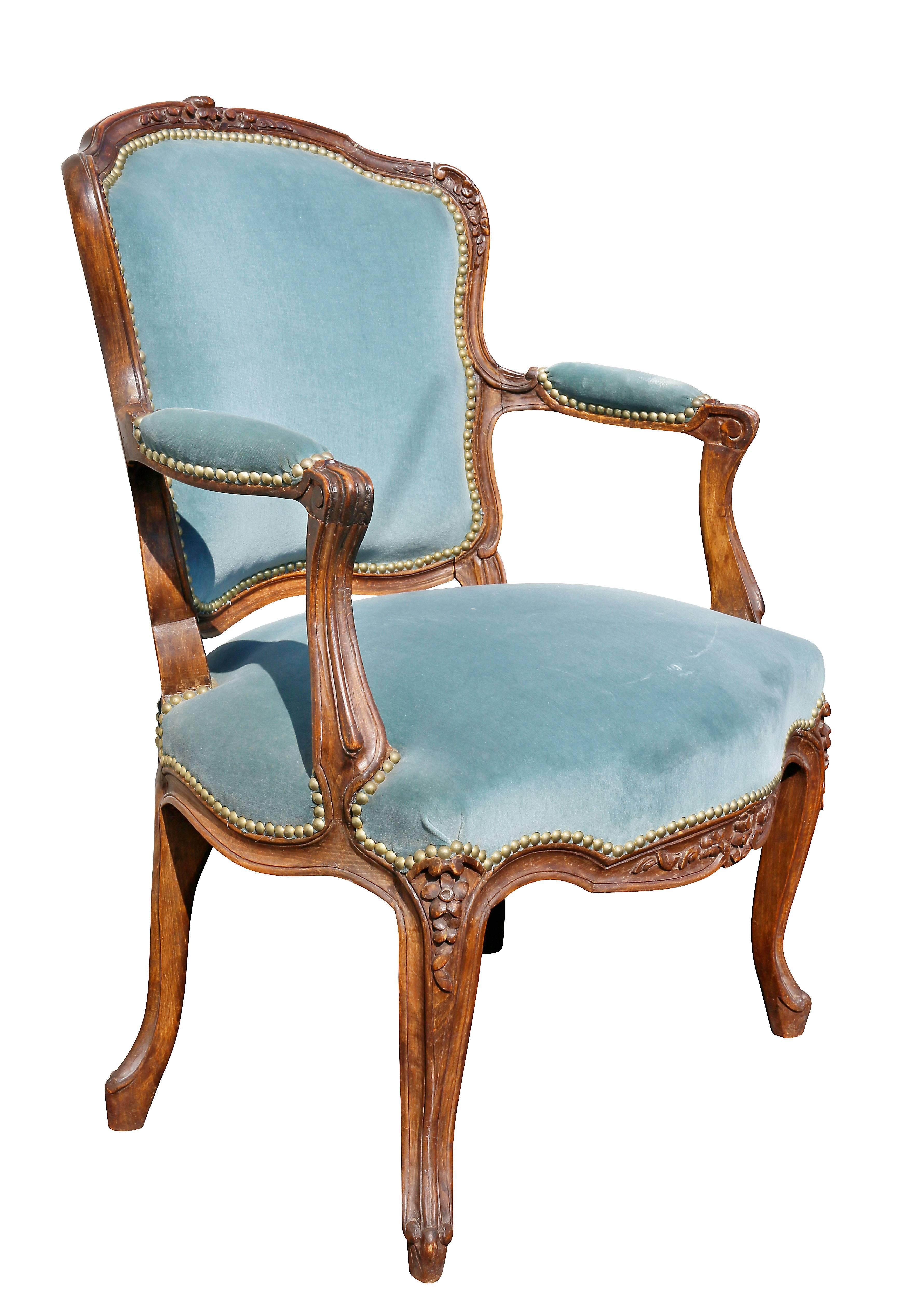 Carved shaped crestrail and upholstered back and seat raised on cabriole legs.