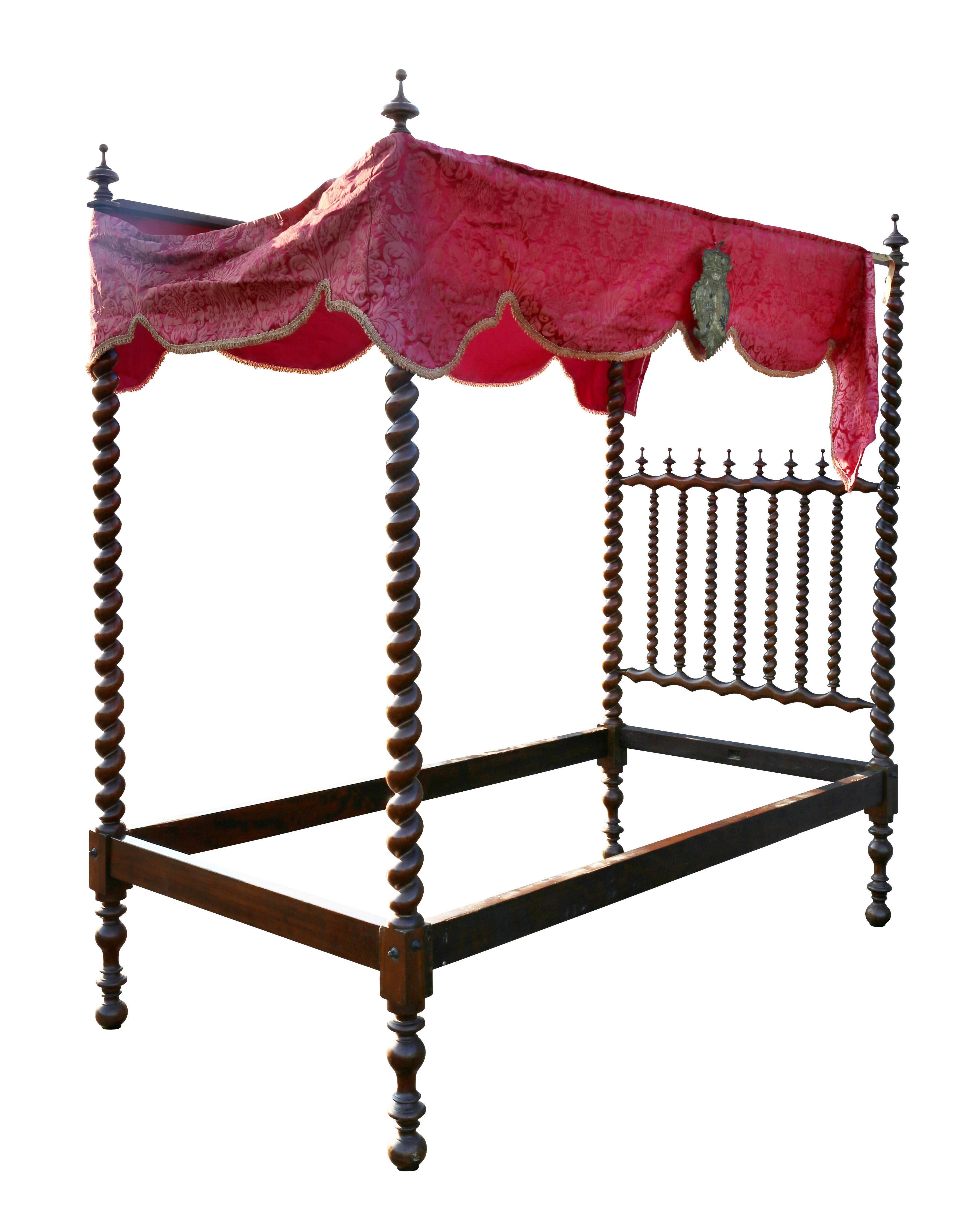 With barley twist supports and conforming headboard, with trim with metallic thread crests.