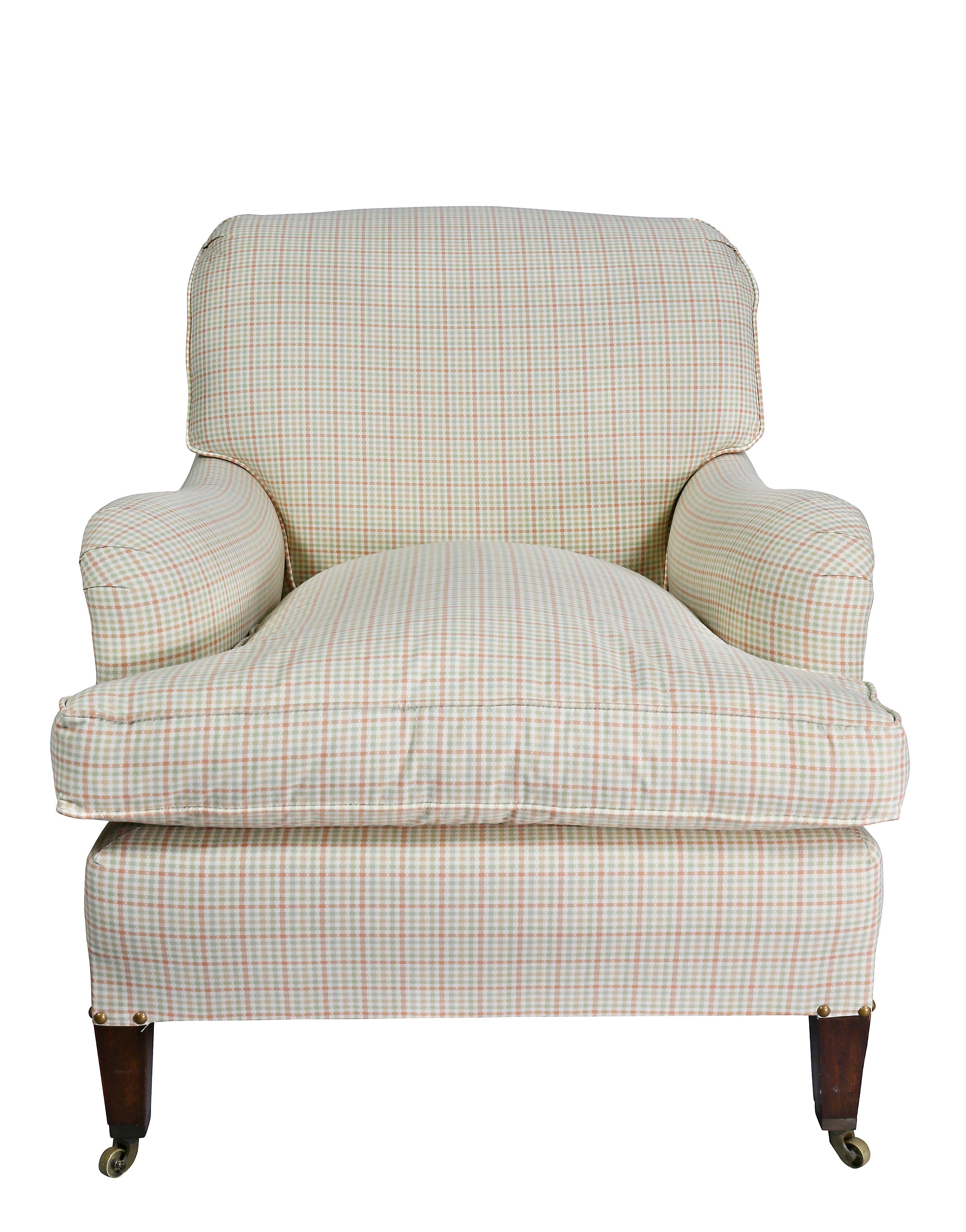 Upholstered scrolled back and shaped arms, loose cushion, square tapered legs with brass casters.