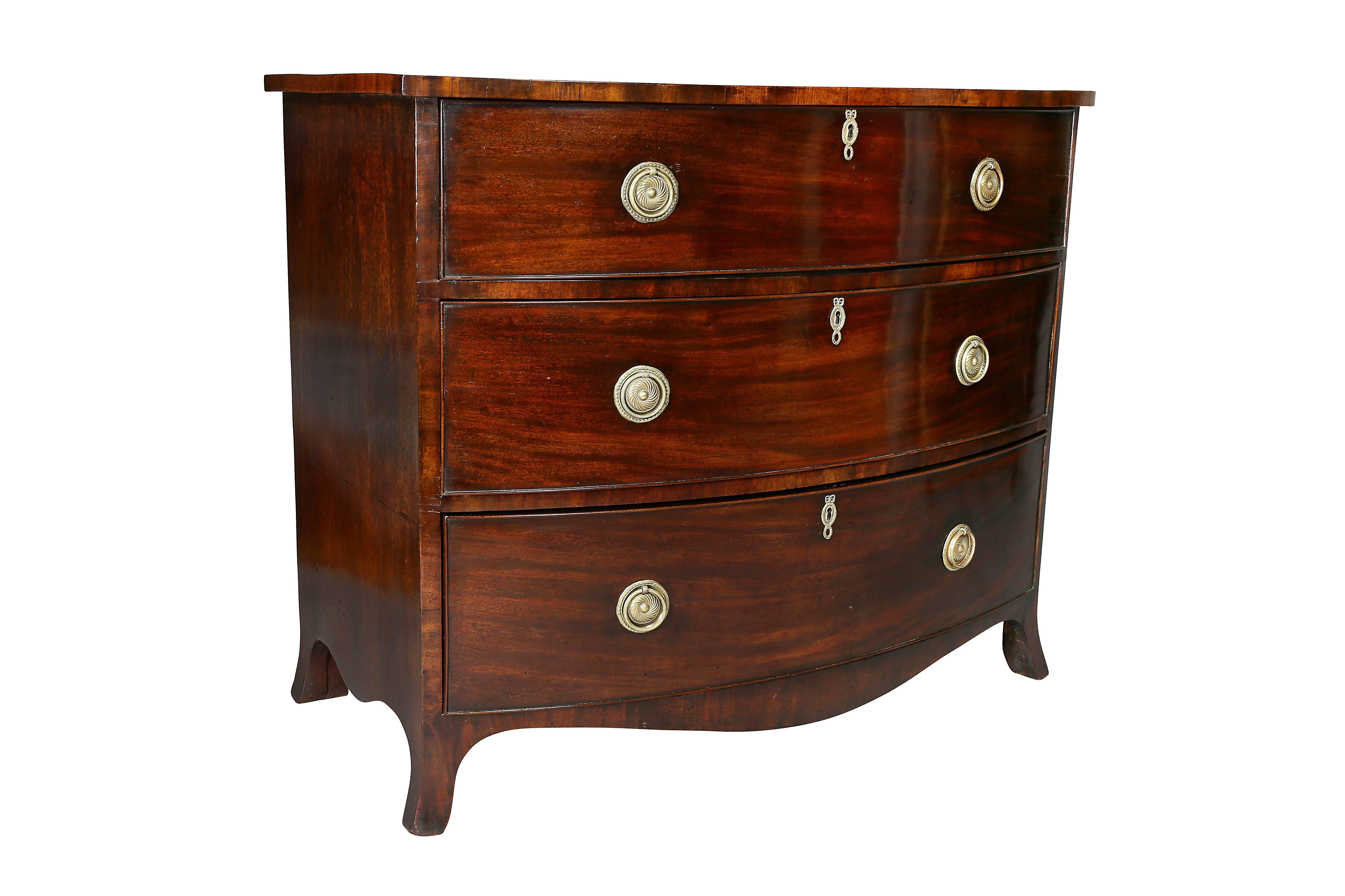 Beautiful color, bow front over three drawers, circular ring handles, splayed legs.