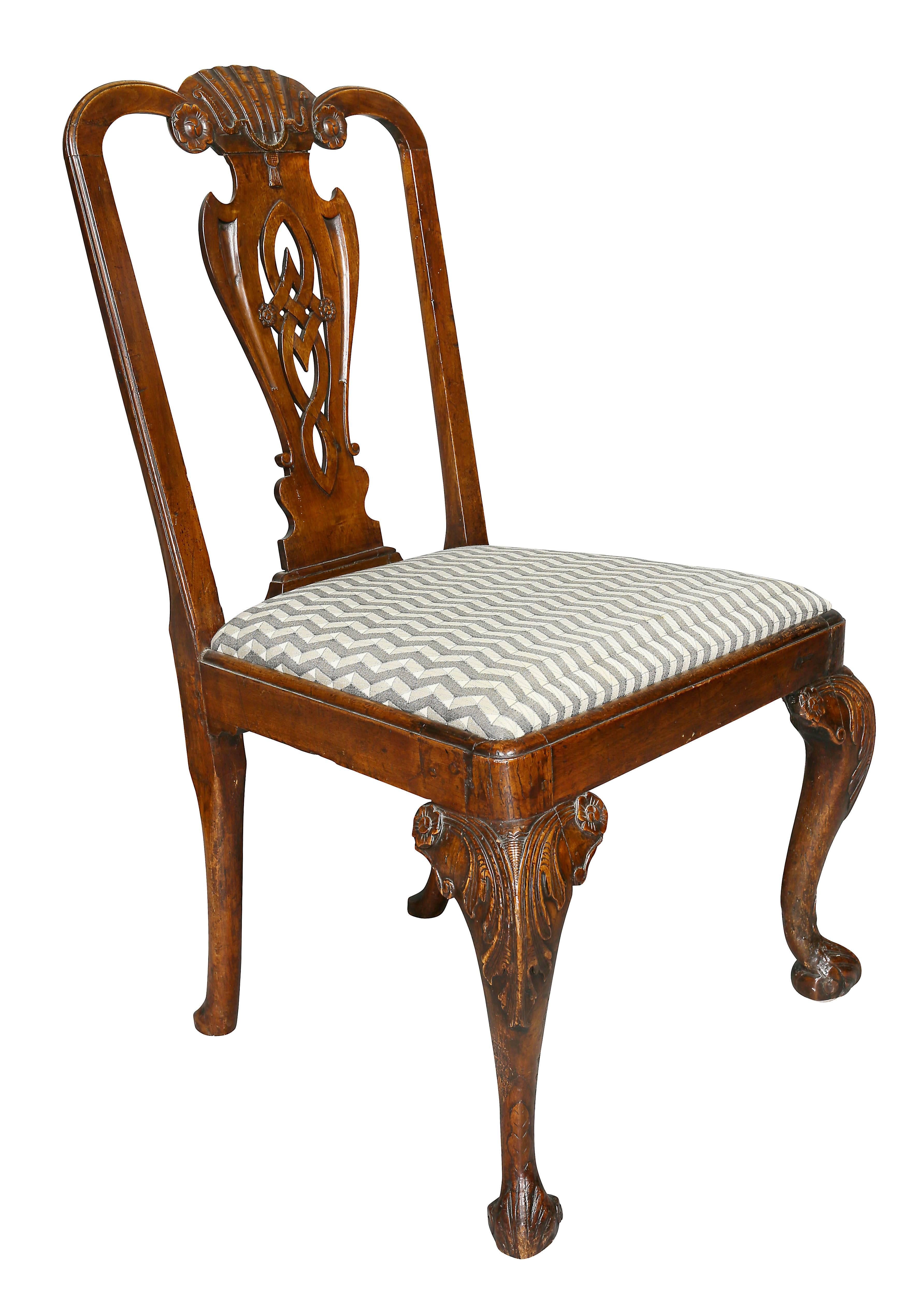 With carved shell and tassel crest rail over a pierced vasiform splat, drop in seat, raised on cabriole legs and scroll feet.