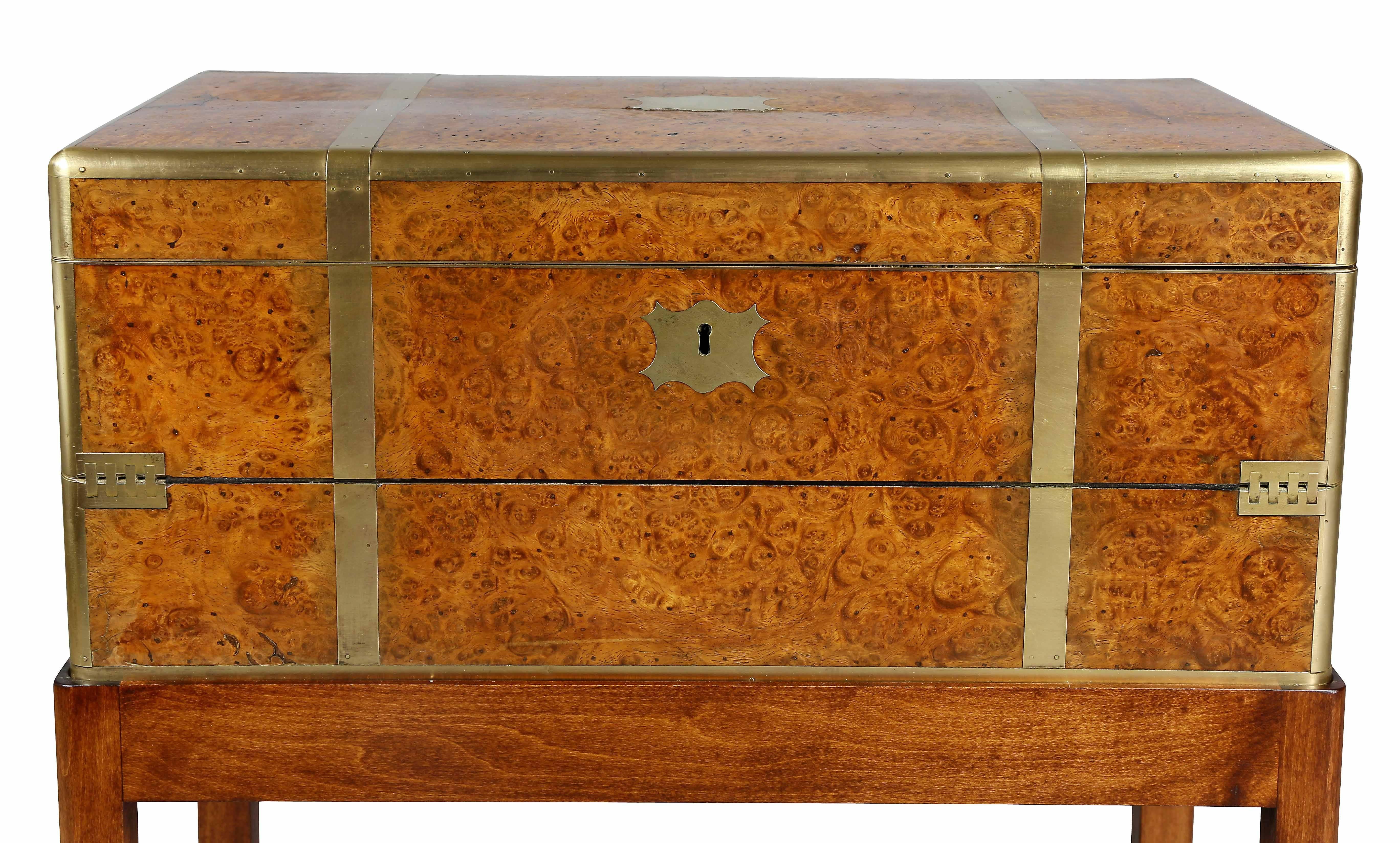 Rectangular with brass corners and trim opening to a desk with writing surface and fitted compartments, later base.