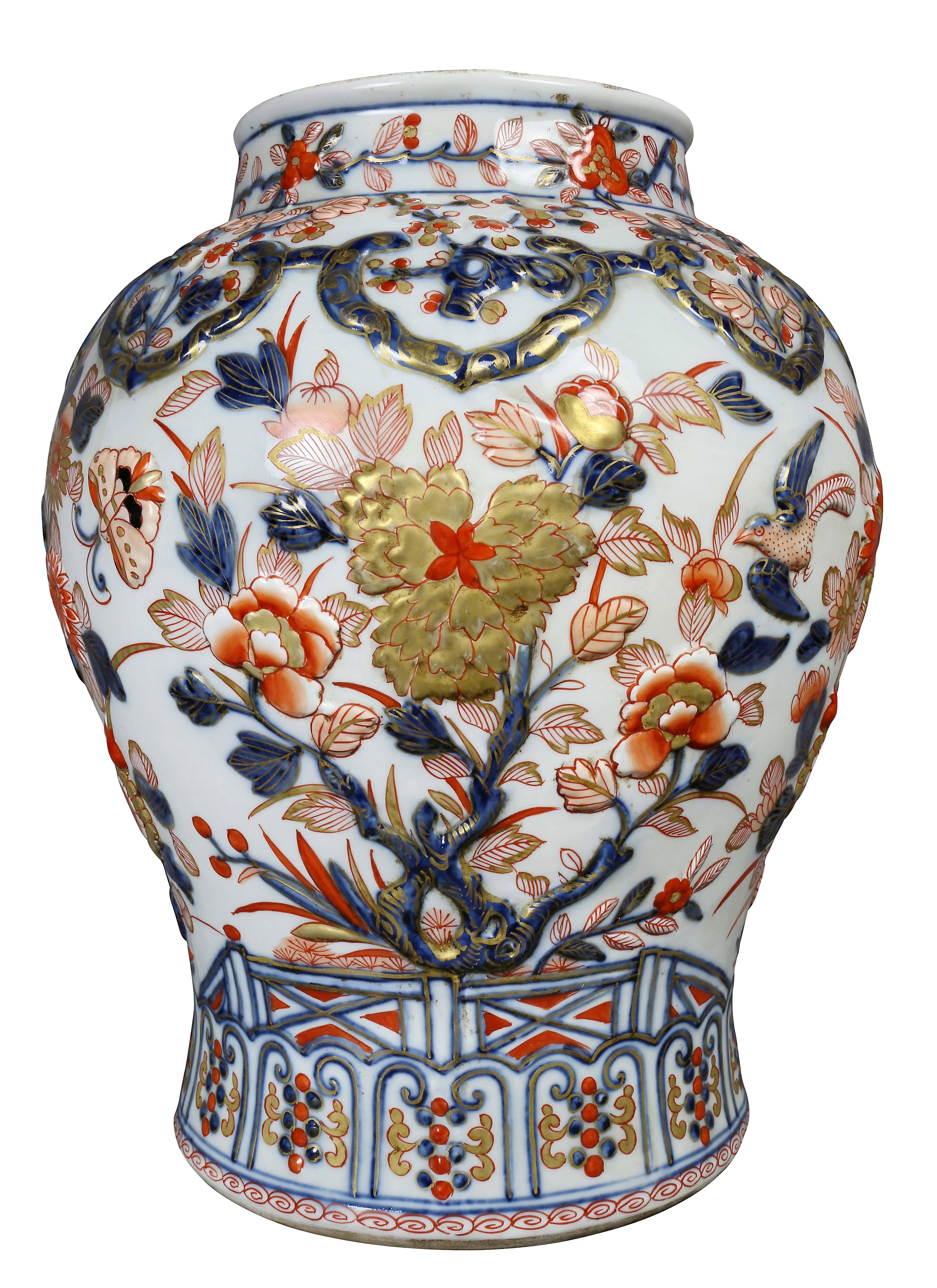 Each with finial and domed covers and baluster body. Raised decoration in the Imari pattern.