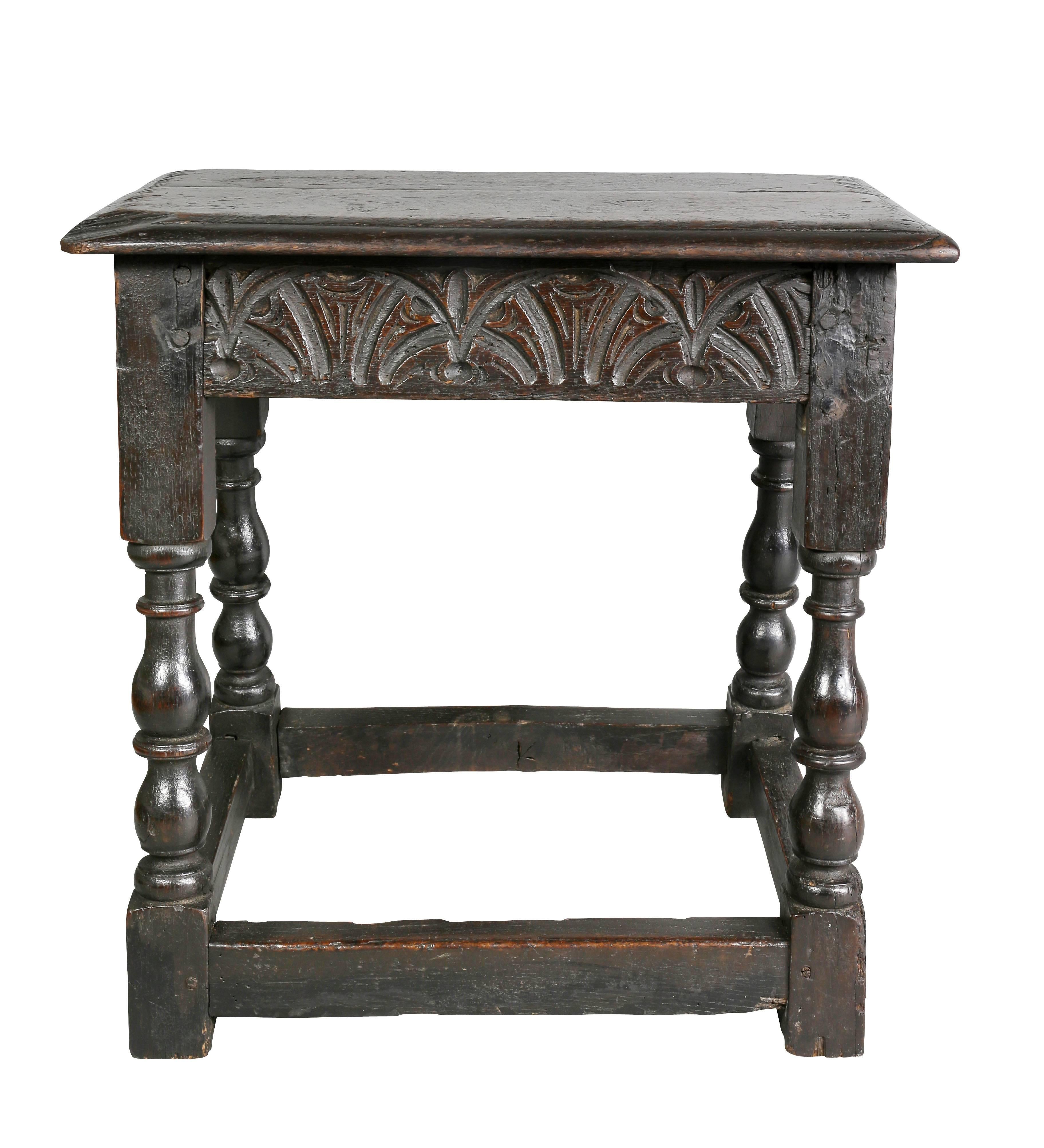 Rectangular top over a carved frieze, turned legs with box stretchers.
