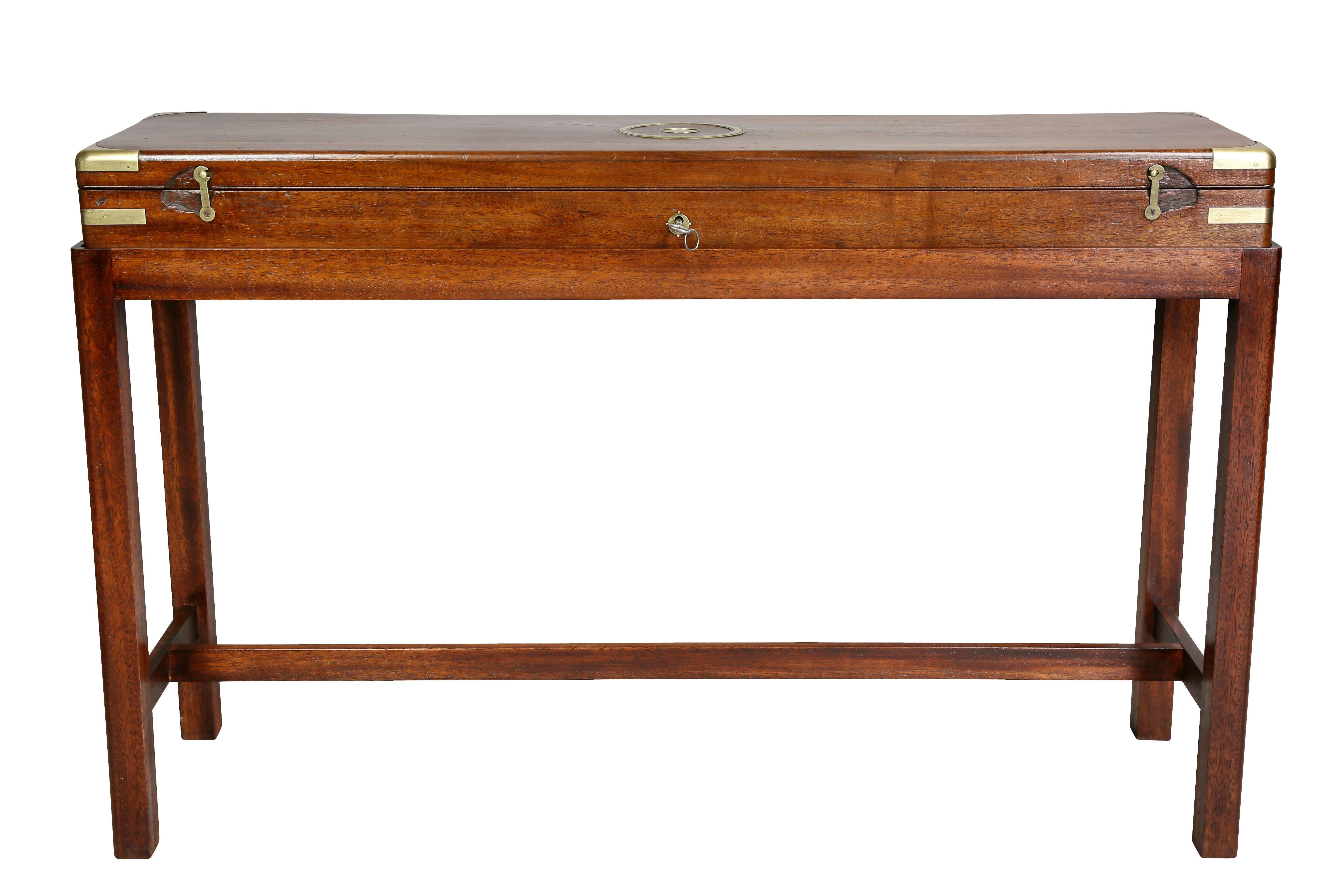 Hinged top opening to a felt lined fitted interior with a gun. Raised on a later mahogany base.