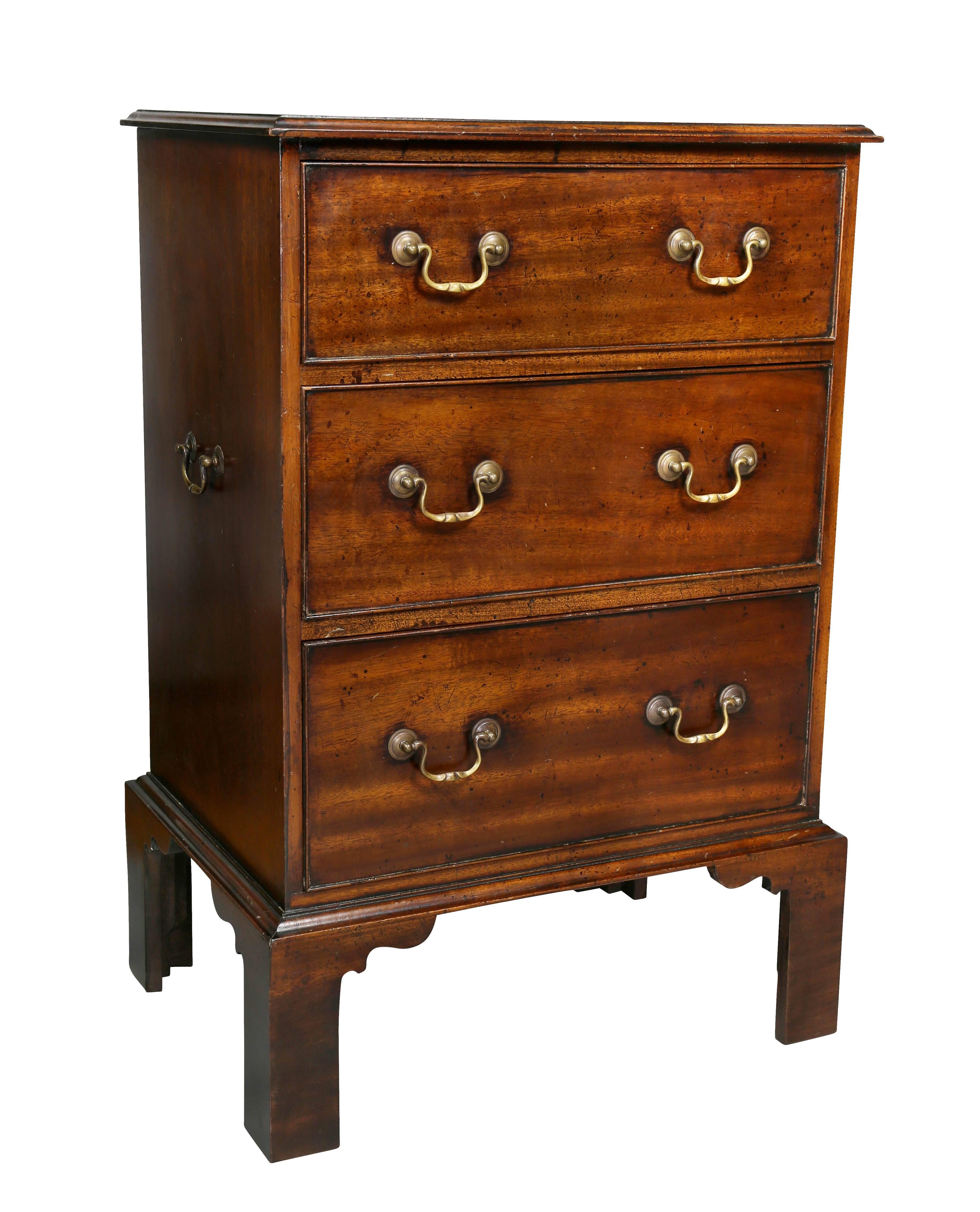 Each with rectangular tops with molded edge over three drawers ending on bracket feet. Handles on sides.