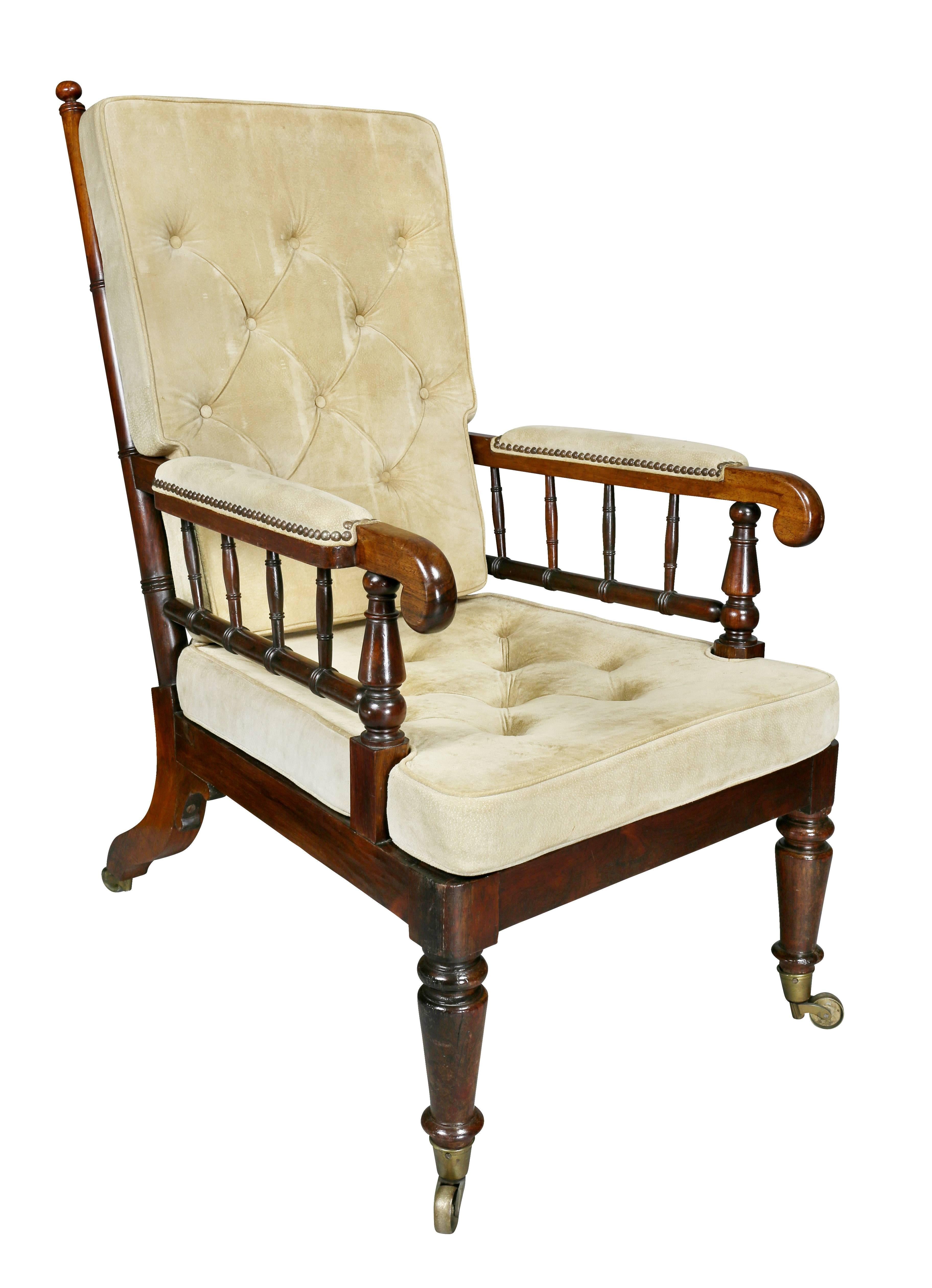 Each with bamboo turned spindle backs and carved down scrolled arms with decorative spindle supports, wood seat rail with loose cushion seat and back raised on turned tapered legs ending on casters. Provenance; Newel Galleries.